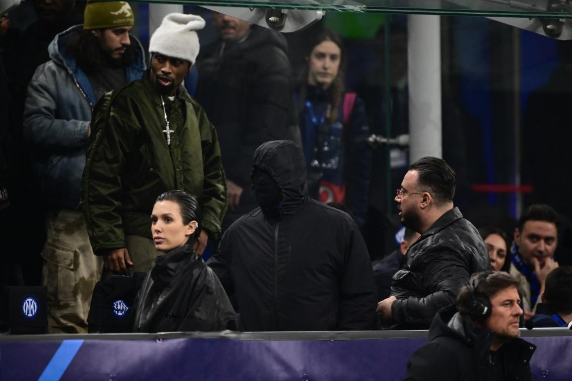 Kanye West wearing a face mask with Bianca Censori at a soccer game