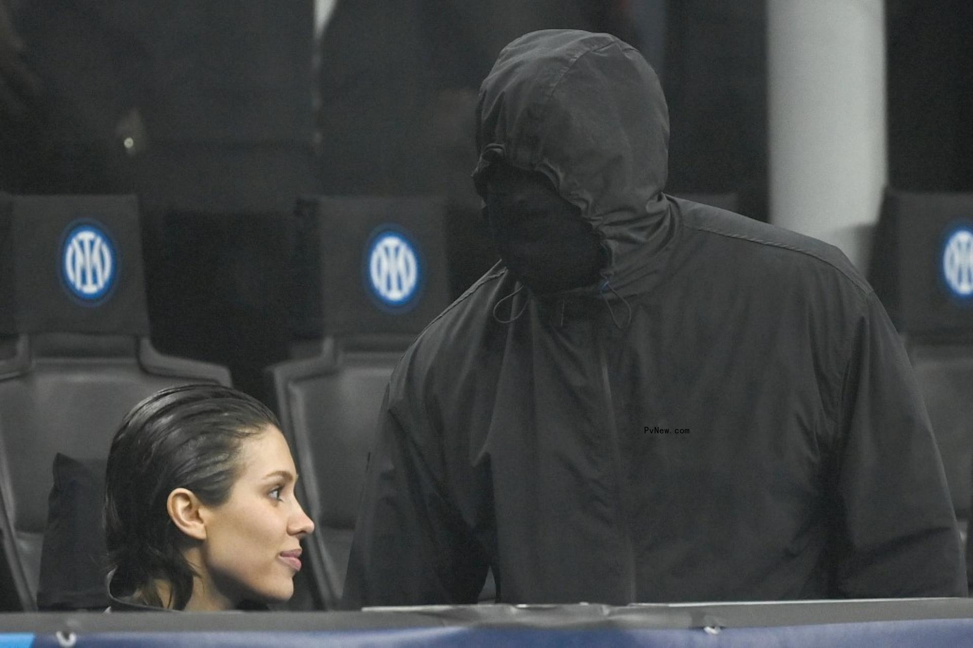 Kanye West wearing a face mask with Bianca Censori at a soccer game