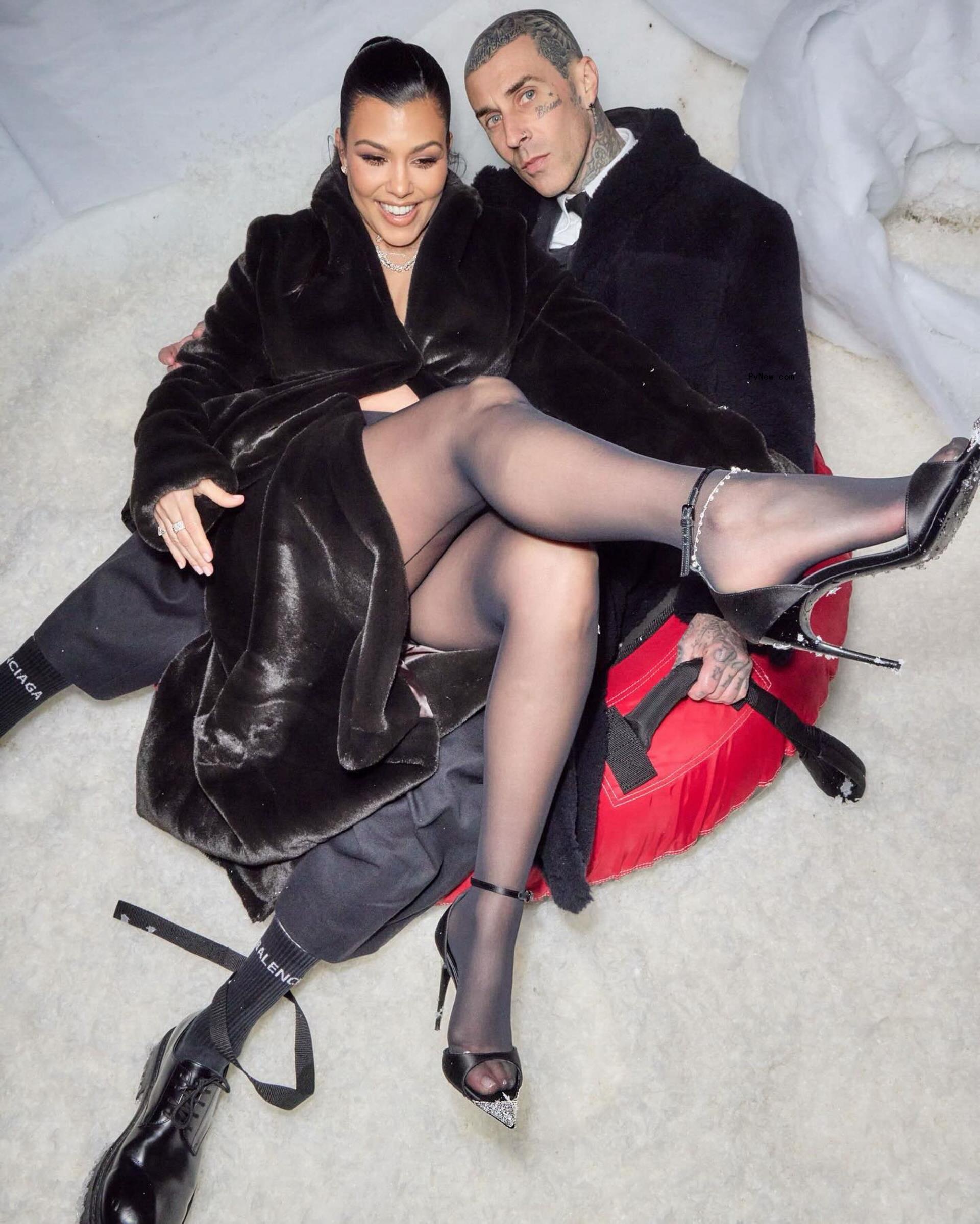 Kourtney Kardashian and Travis Barker sitting together