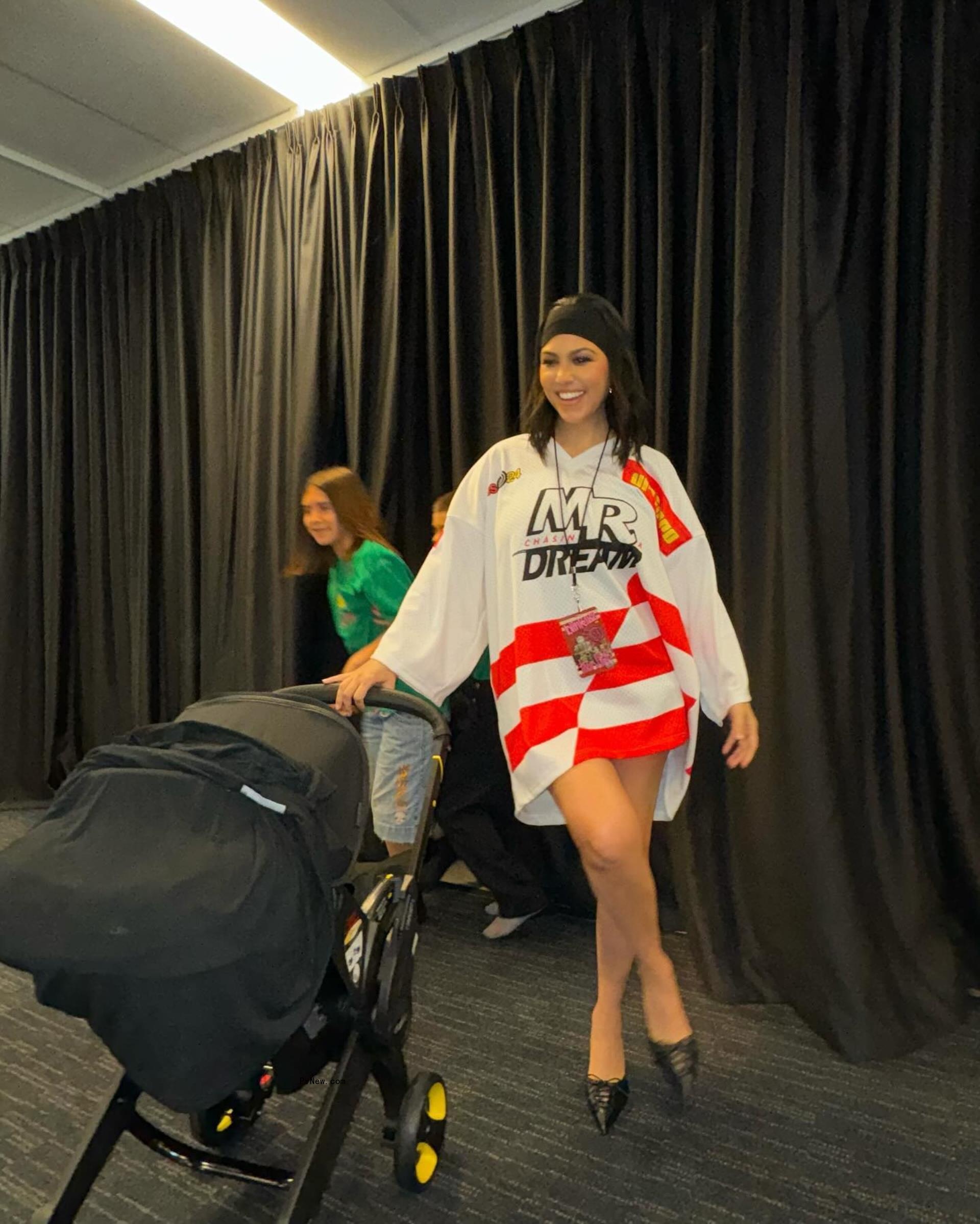 Kourtney Kardashian posing in a jersey with no pants