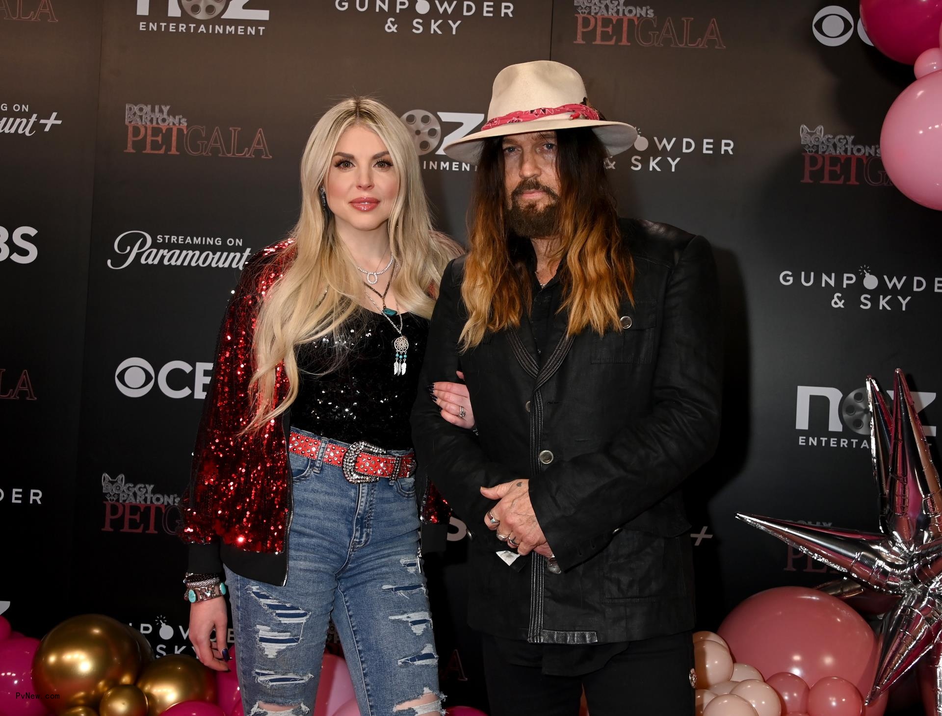Firerose and Billy Ray Cyrus smiling for a photo at Dolly Parton's Pet Gala event in Nashville.