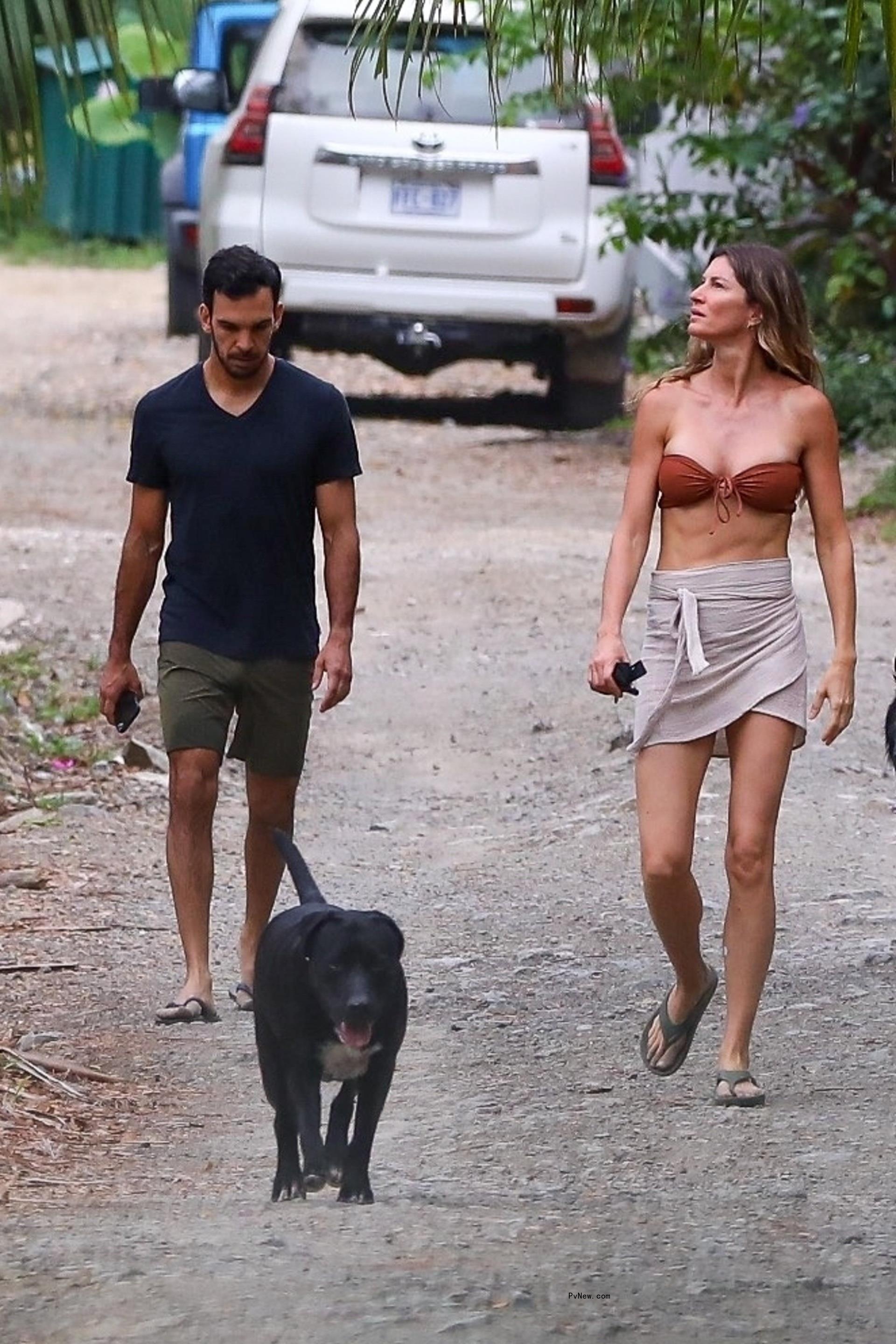 Gisele Bündchen strolls with Joaquim Valente and a dog.
