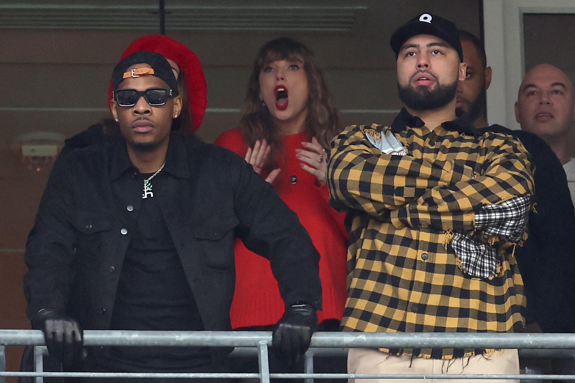 Ross Travis and Taylor Swift watching a football game.