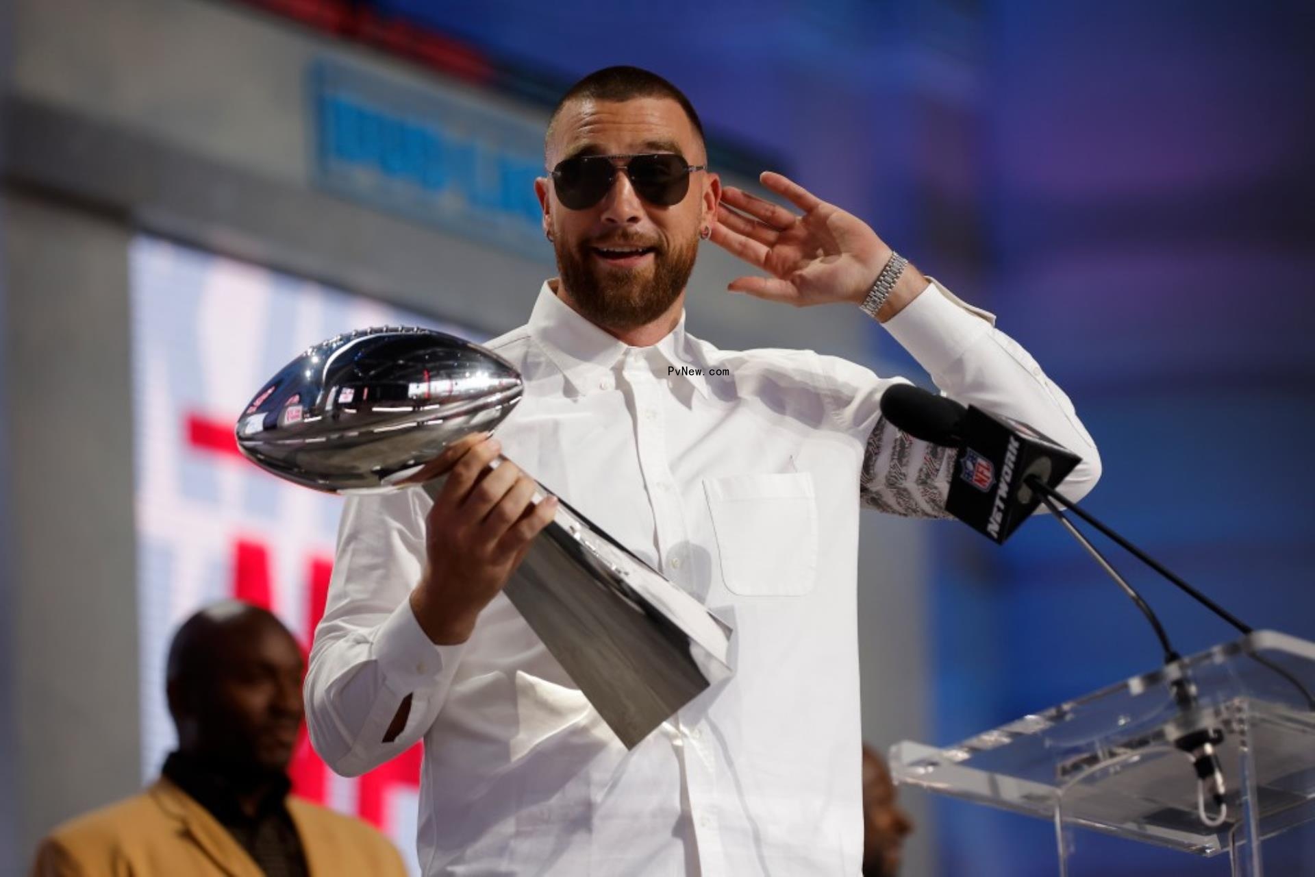 Travis Kelce smiling with the Vince Lombardi Trophy