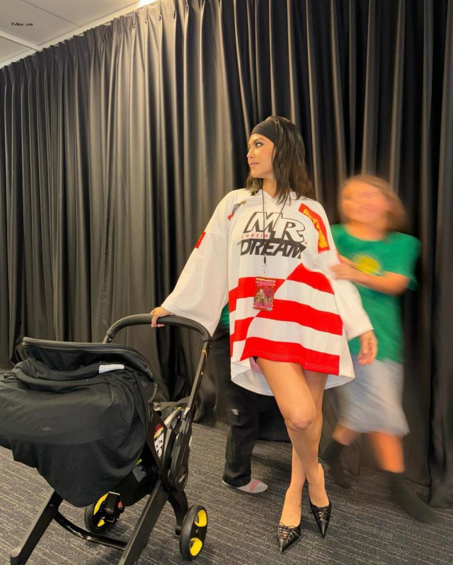 Kourtney Kardashian in an oversized jersey