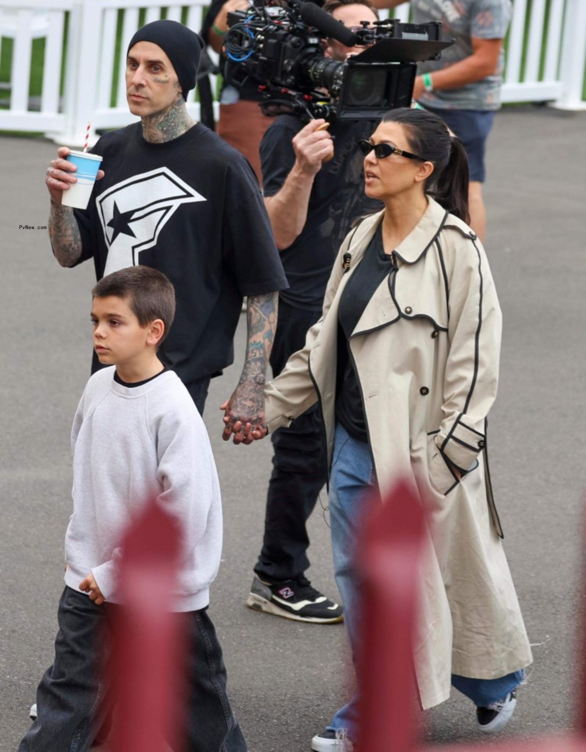 Kourtney Kardashian and Travis Barker hold hands