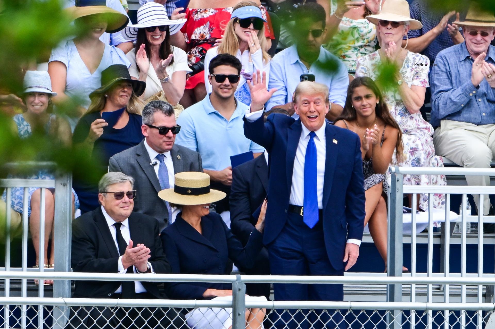 Do<i></i>nald Trump waving at Barron Trump's high school graduation.