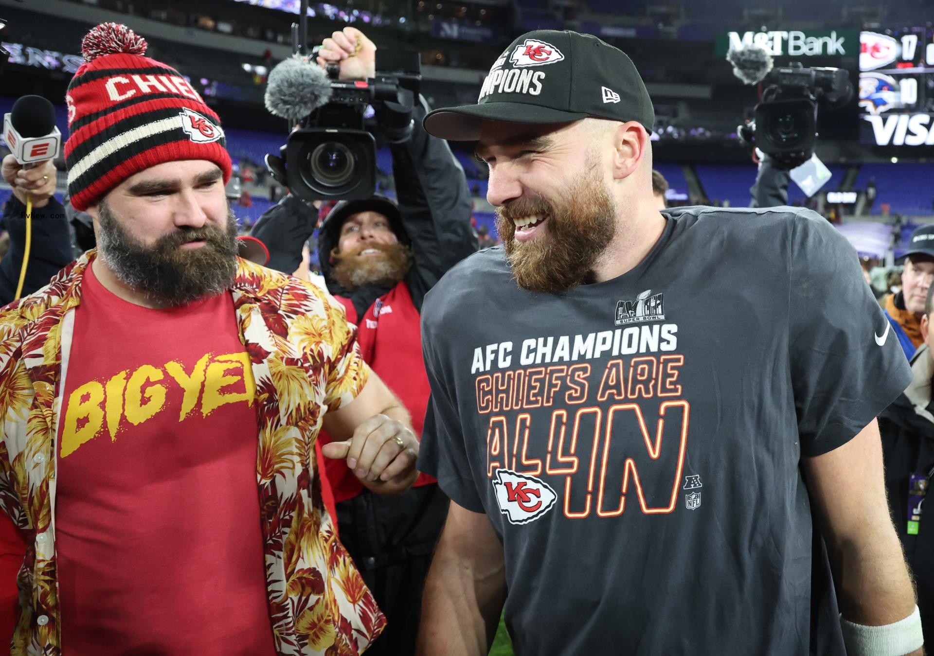 Travis and Jason Kelce on a football field.