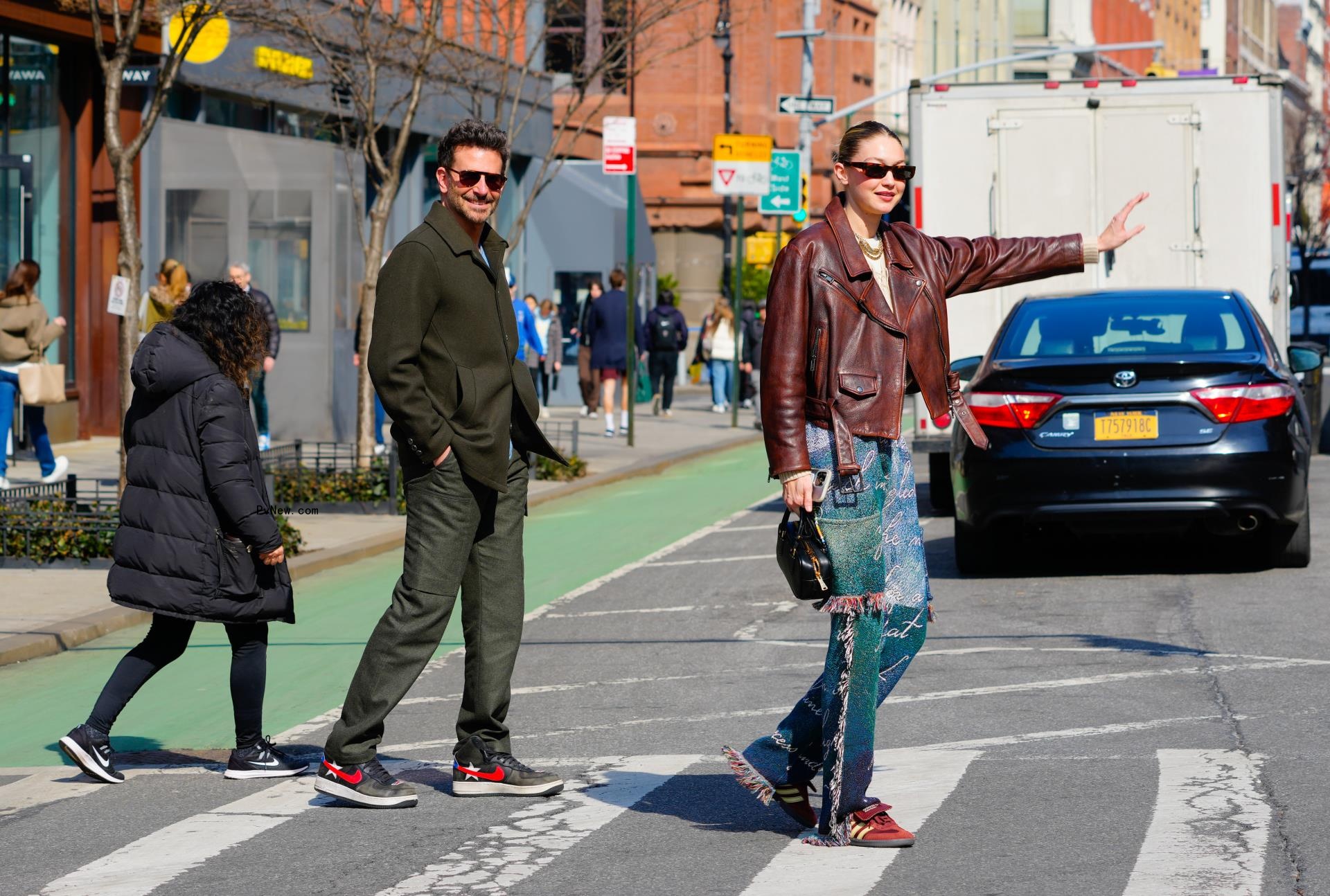 Gigi Hadid and Bradley Cooper stand in a street in NYC.