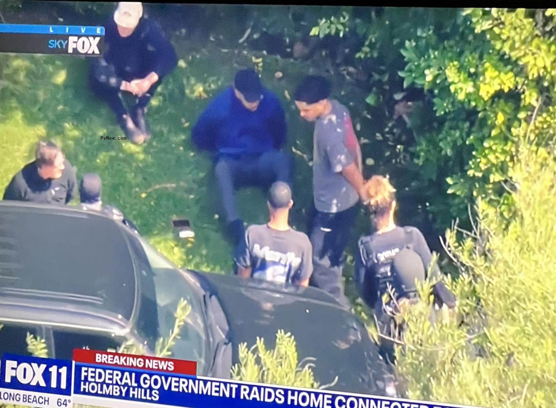 His sons Justin and King appeared to be in handcuffs while talking to officers.