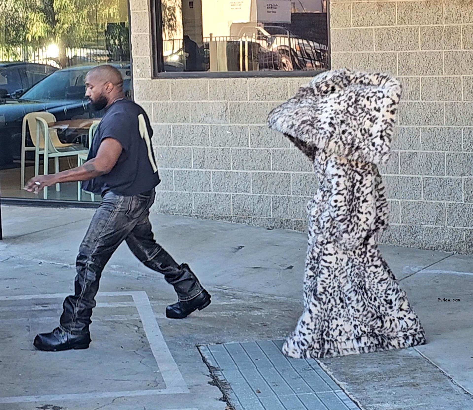 Kenye West strolls through Los Angeles with his scantily clad wife Bianca Censori.