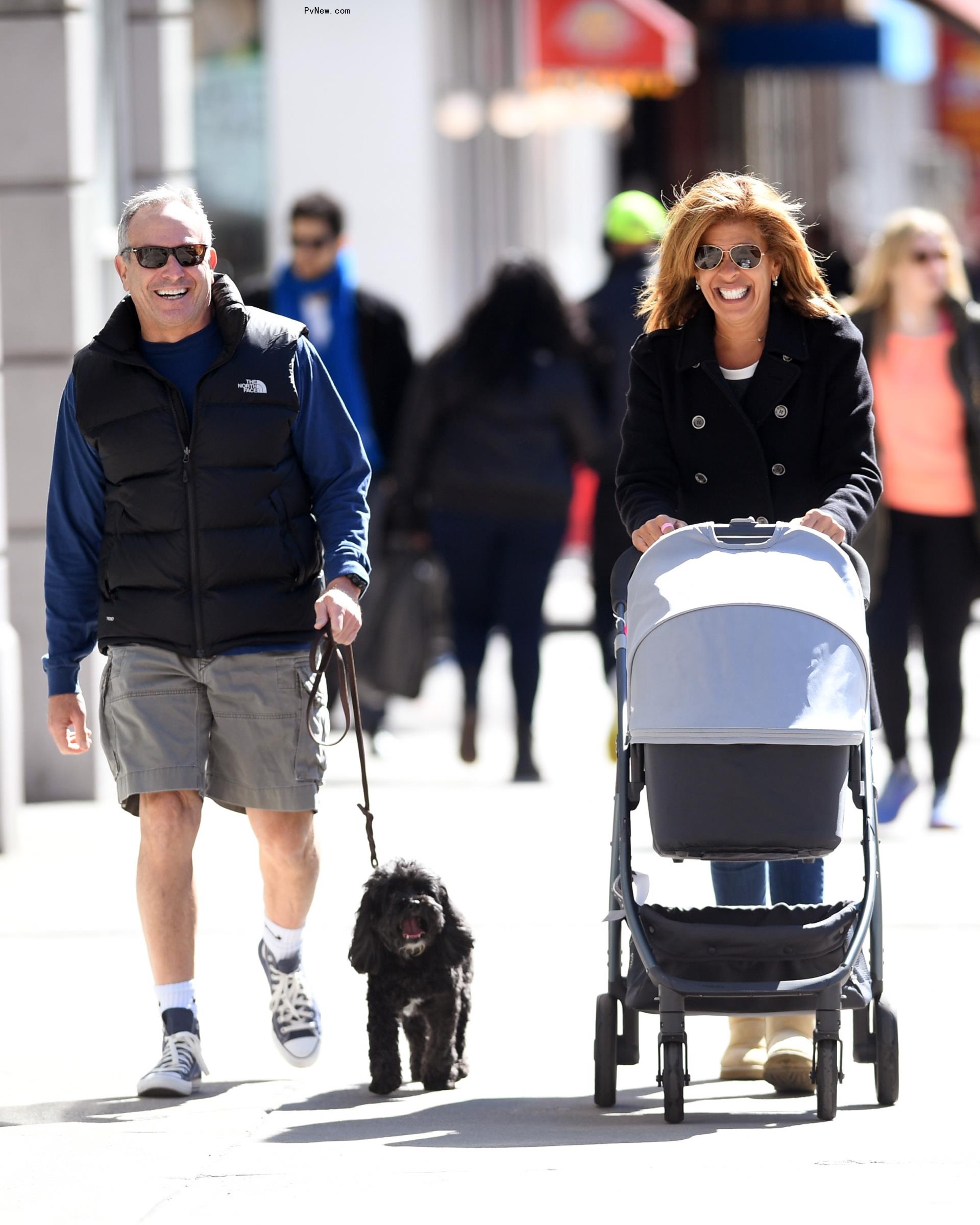 Joel Schiffman and Hoda Kotb walking together with a stroller and dog.
