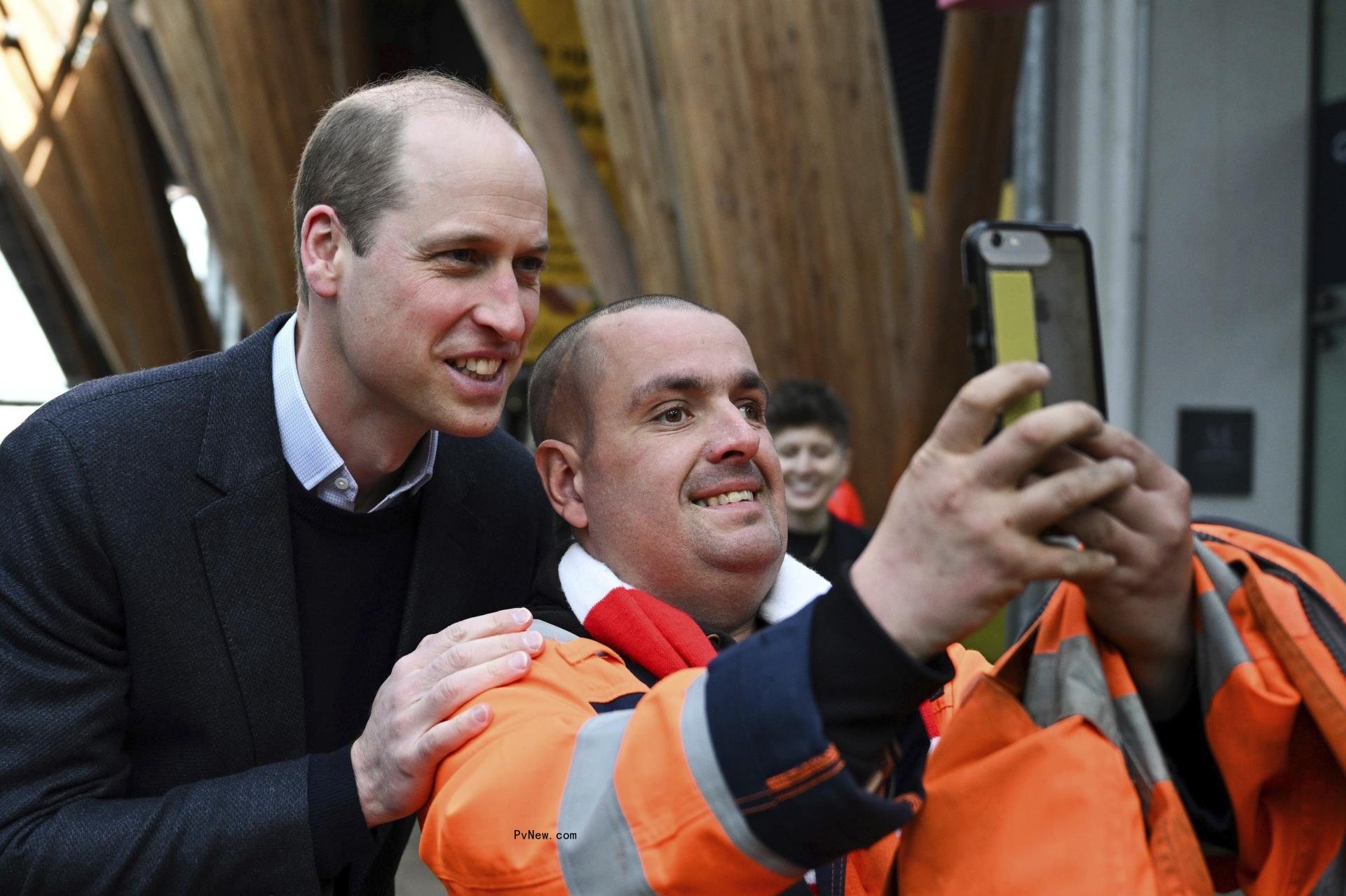 Prince William taking a selfie with a fan.