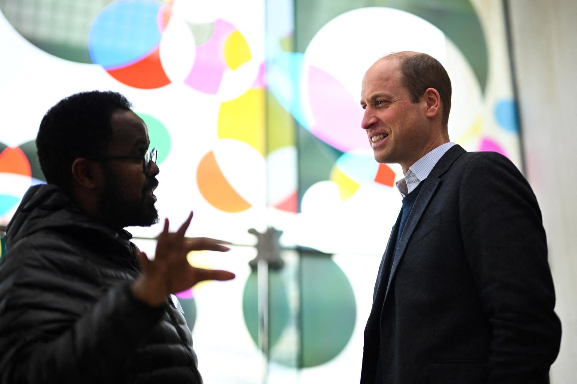 Prince William speaking with someone.