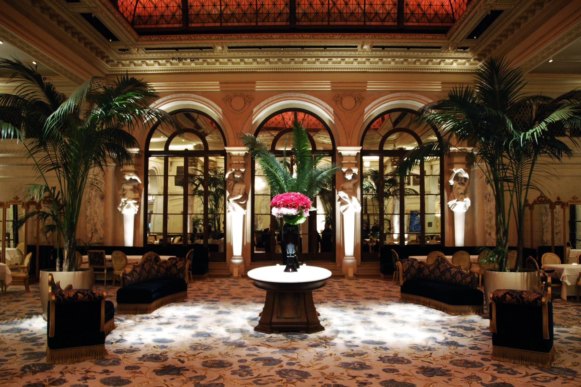 The Oak Room overview, showing velvet sofas, a large table with flowers, and several chairs