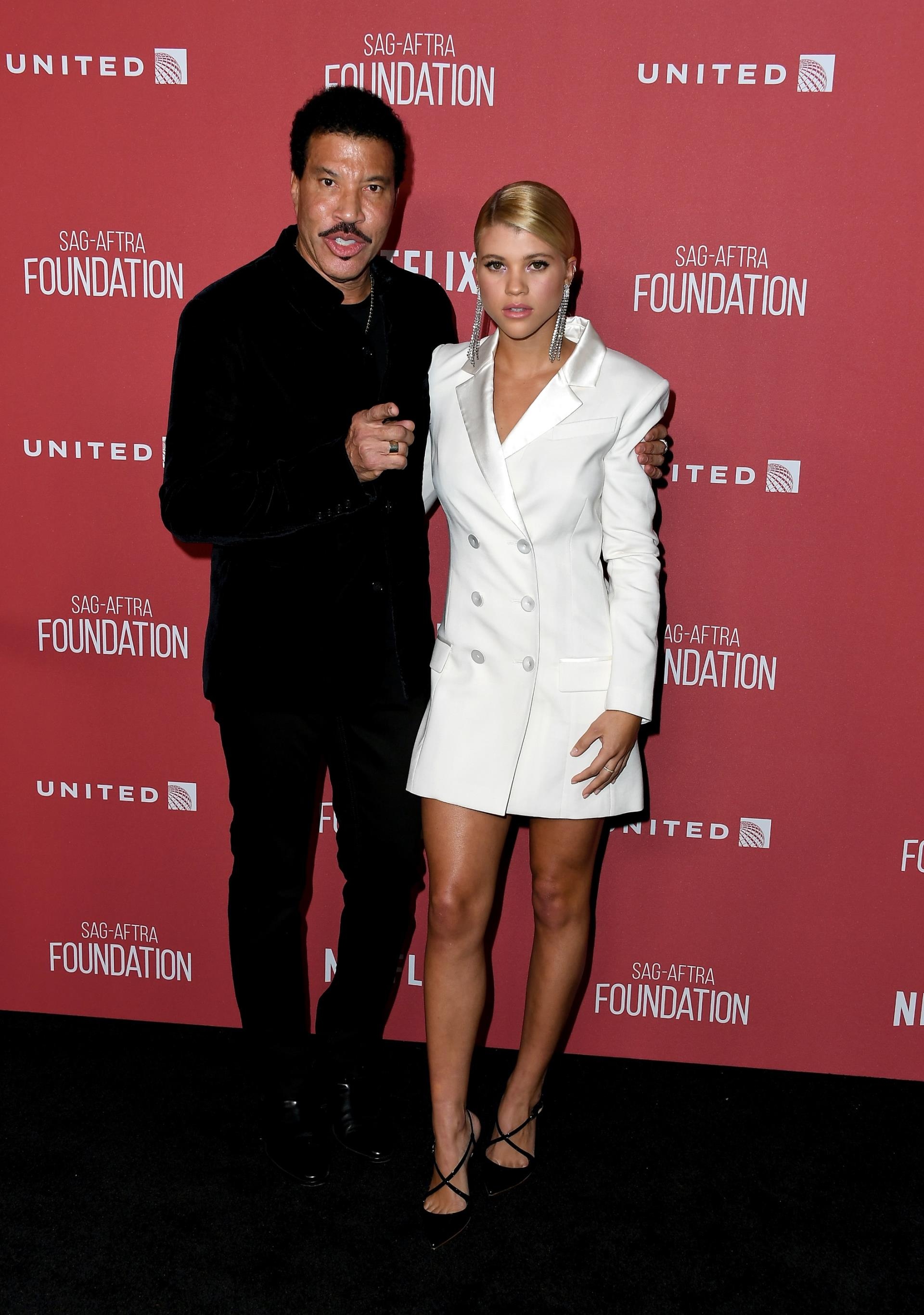Lio<i></i>nel Richie and Sofia Richie on a red carpet.