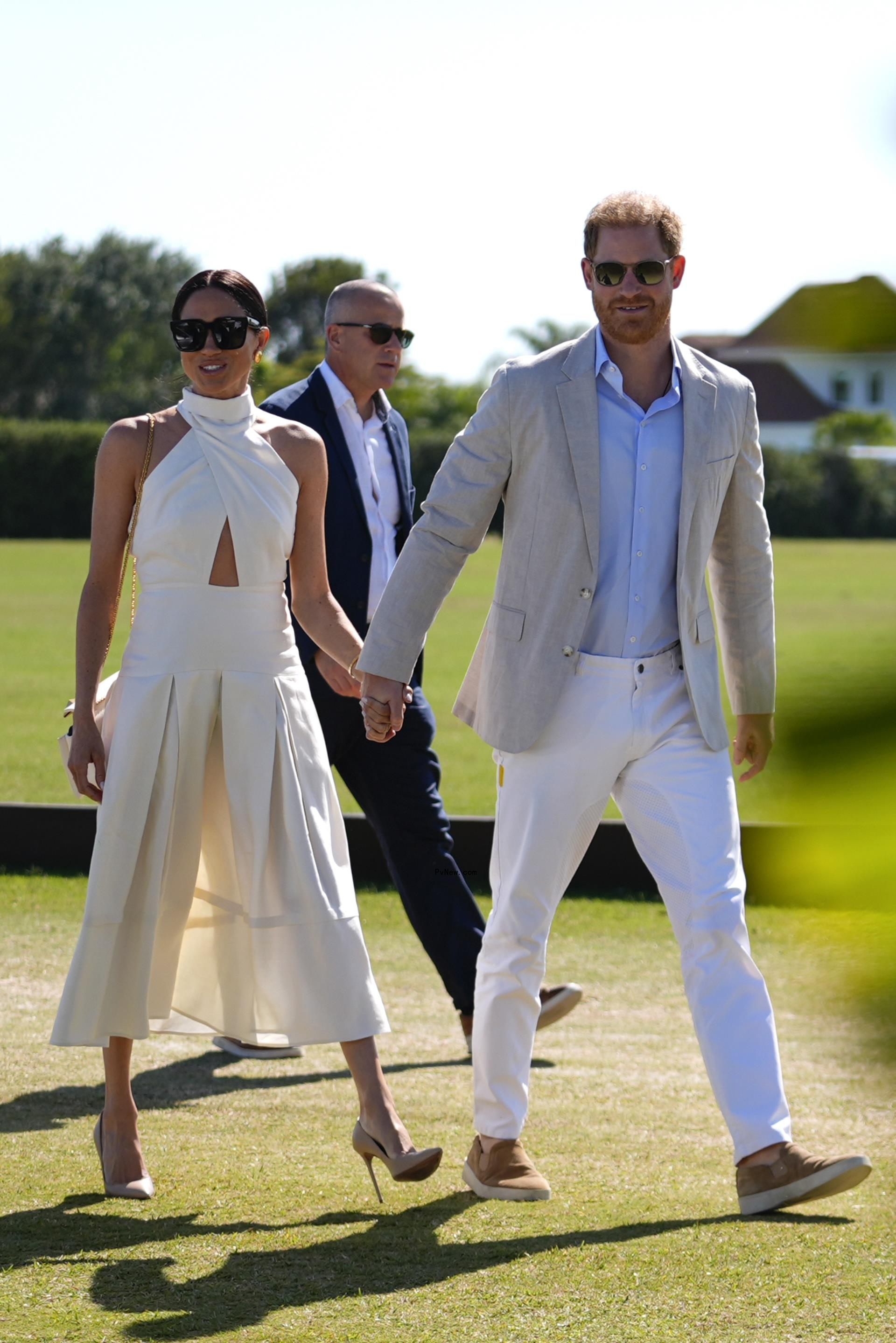 Prince Harry and Meghan Markle walk and hold hands