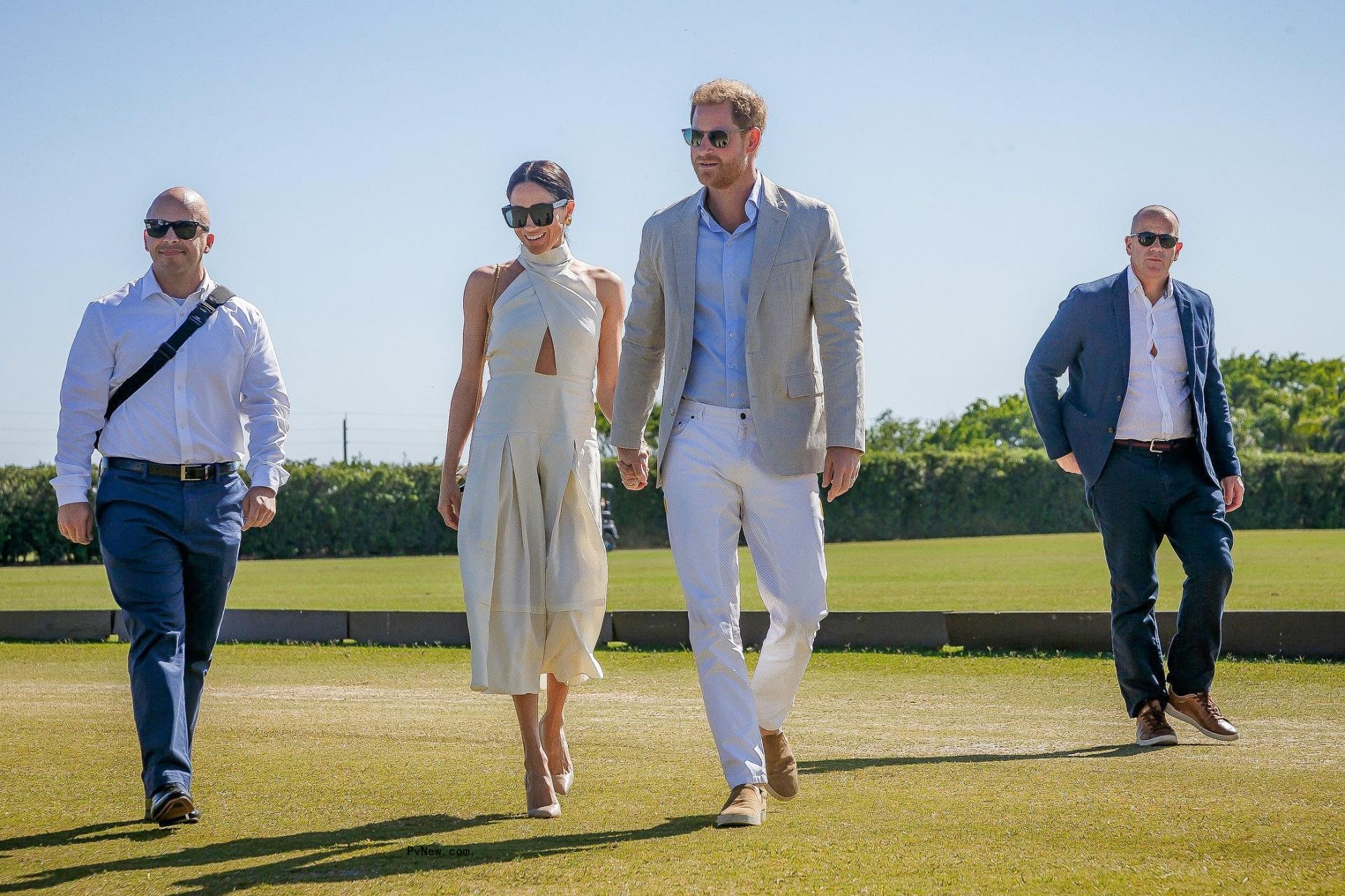Prince Harry and Meghan Markle hold hands