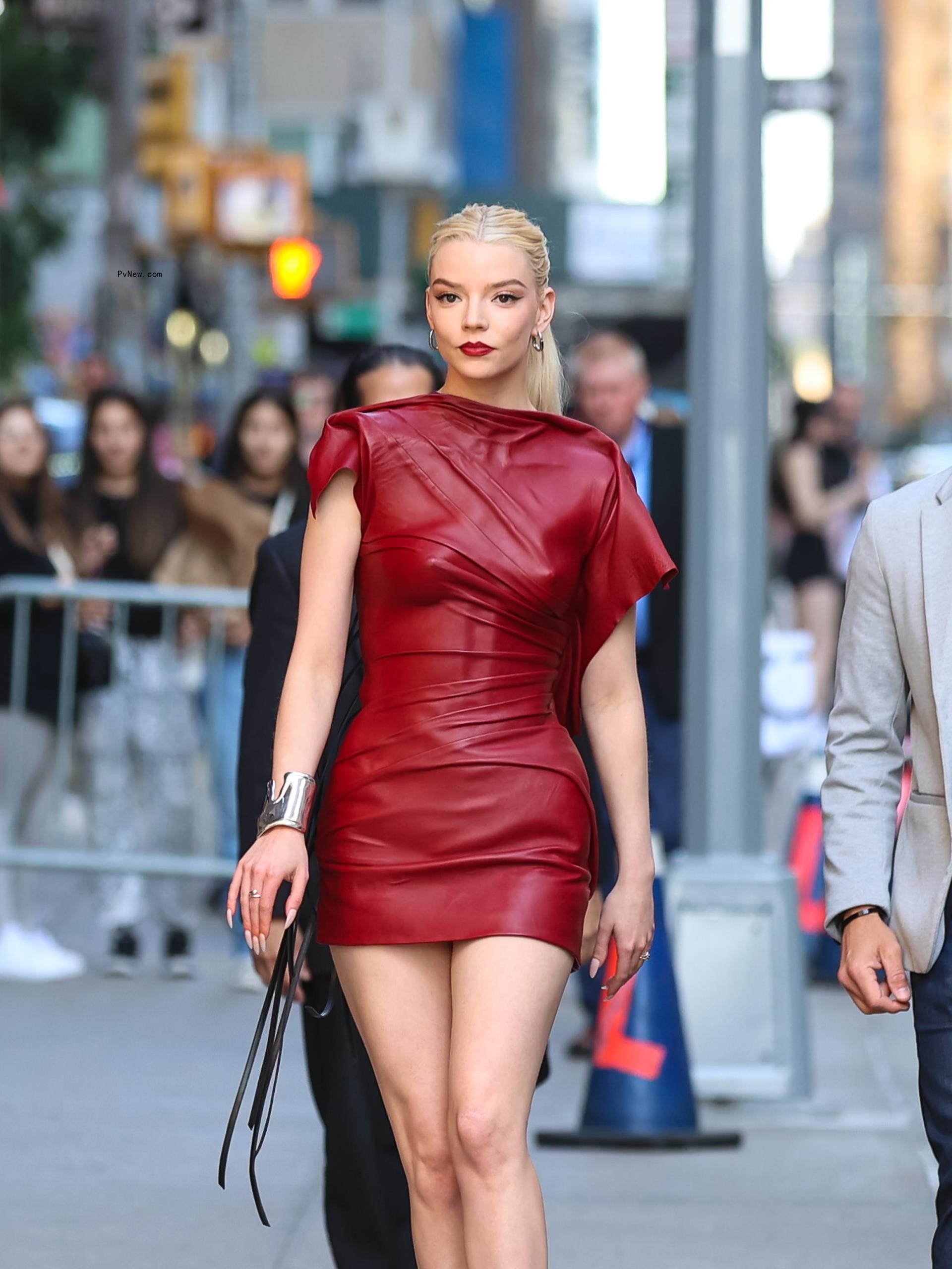 Anya Taylor-Joy wearing a red leather minidress