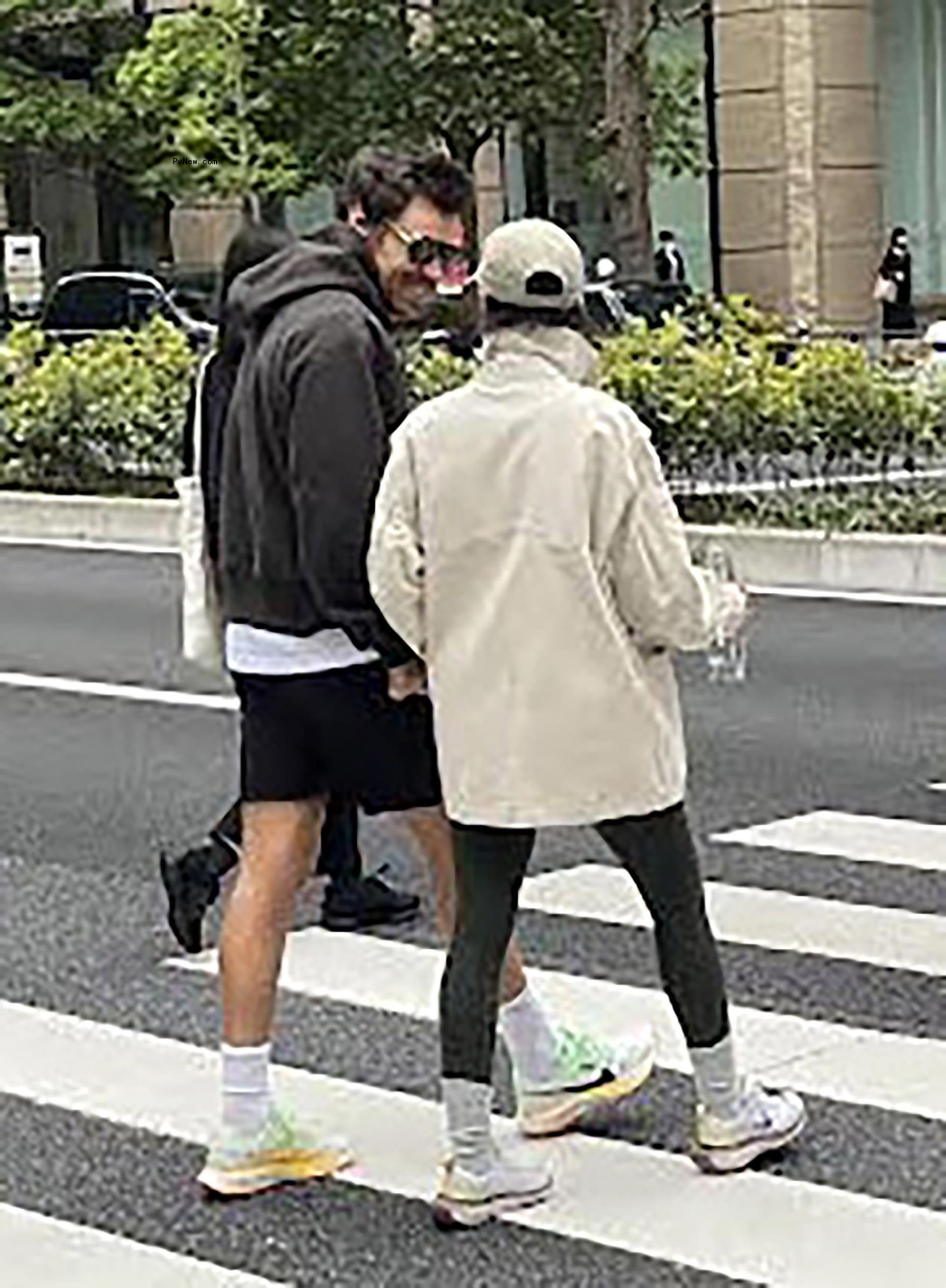 Harry Styles and Taylor Russell holding hands in Tokyo.