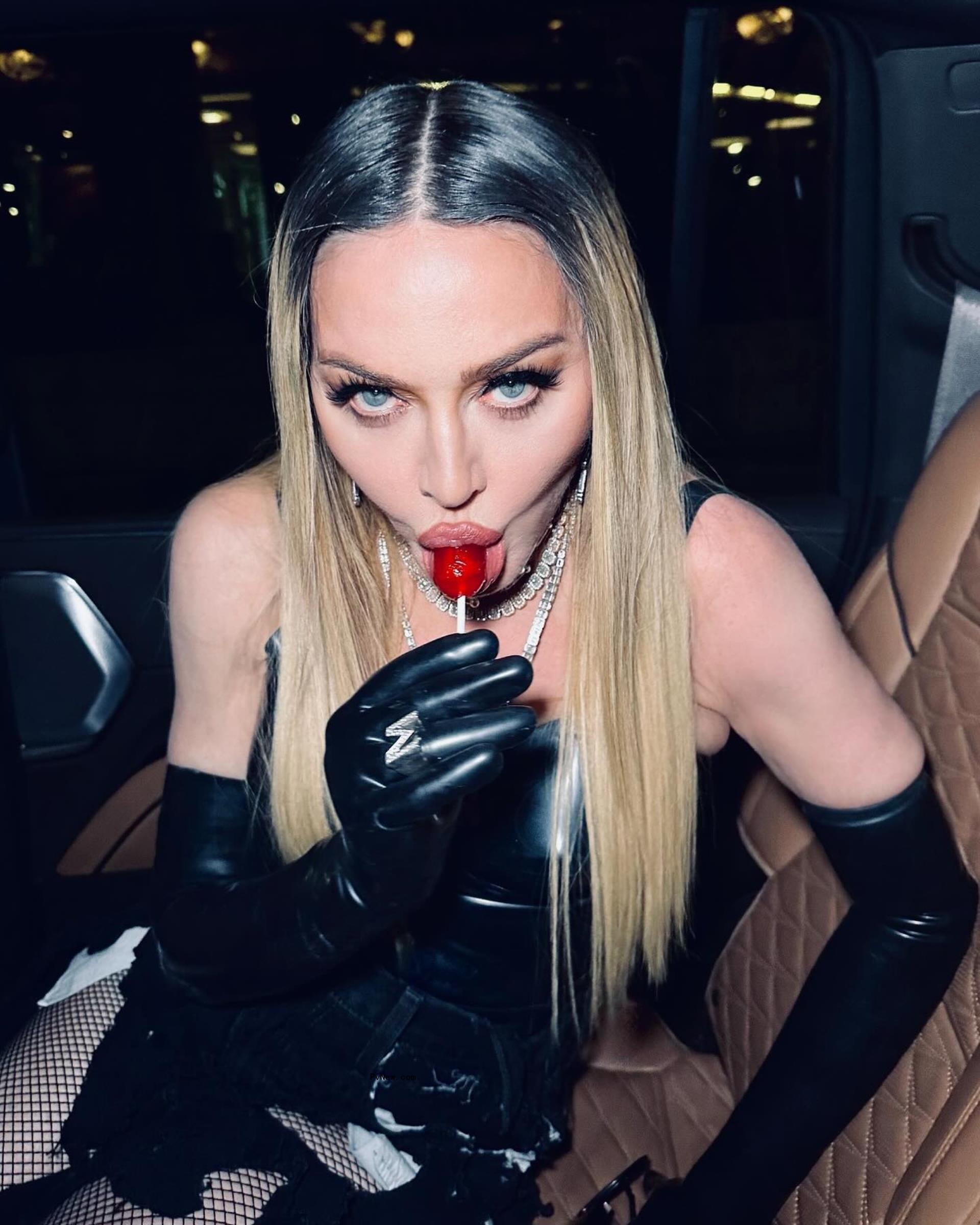 Mado<i></i>nna eating a lollipop.