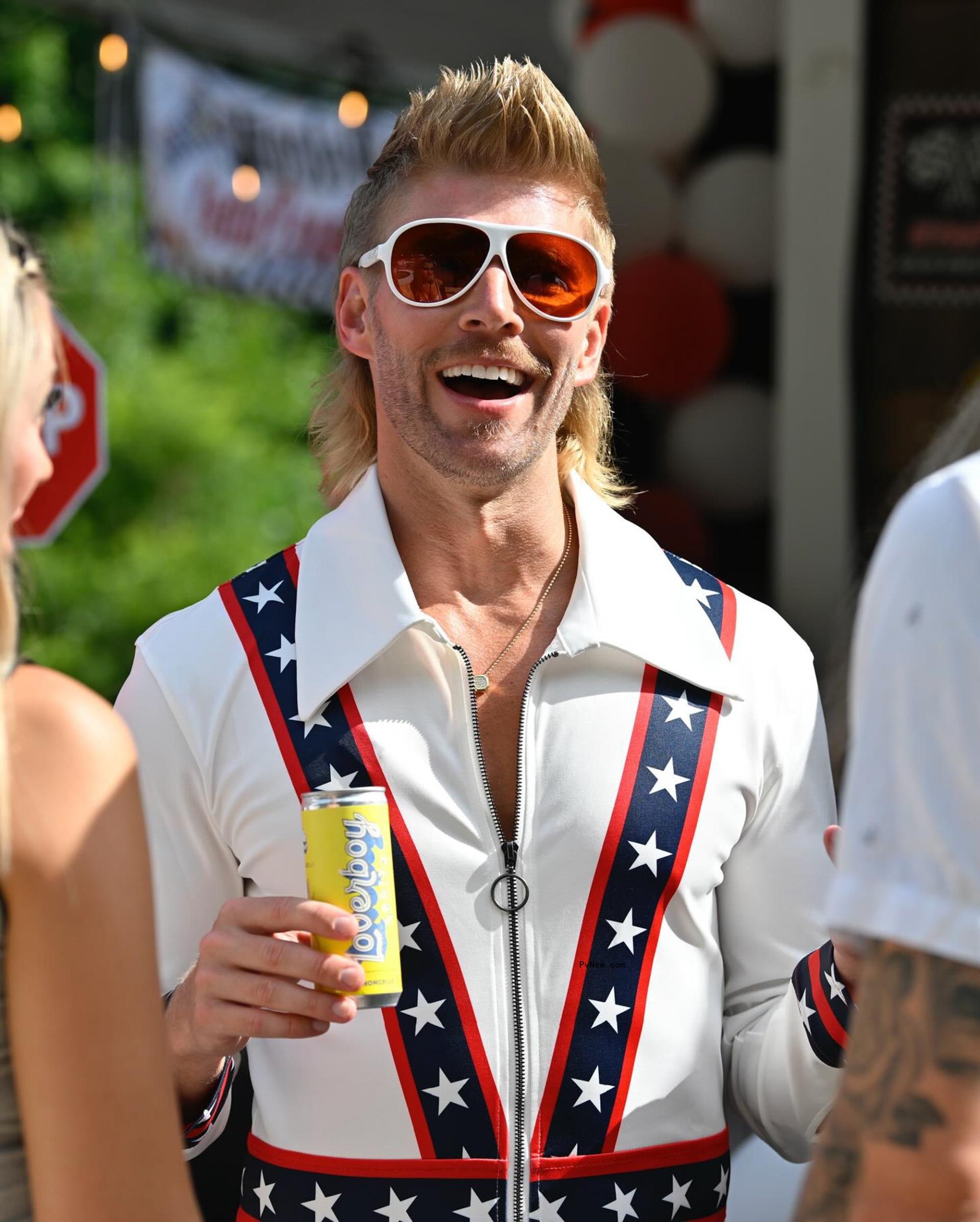 Kyle Cooke holding a drink