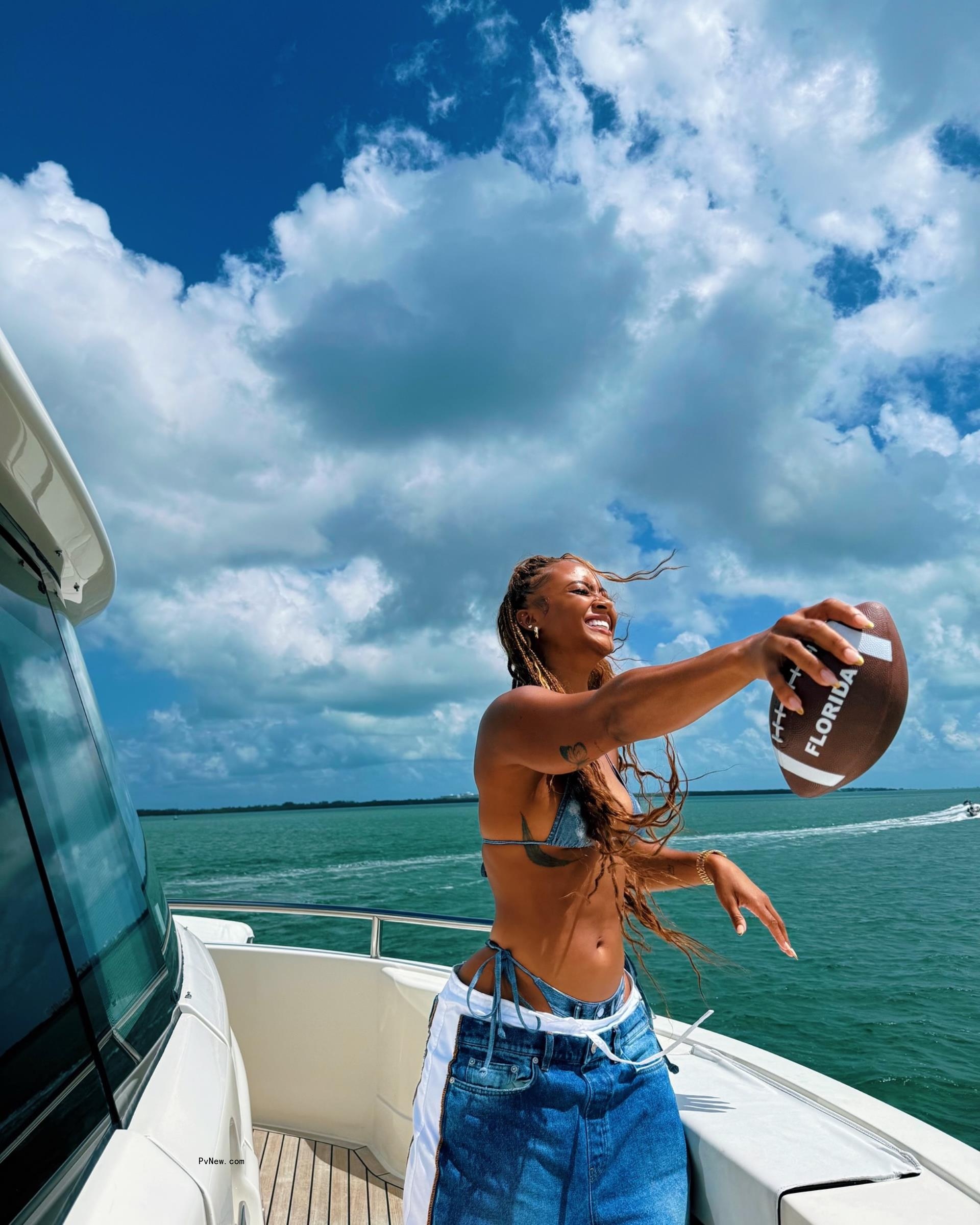 Kayla Nicole holding a football.