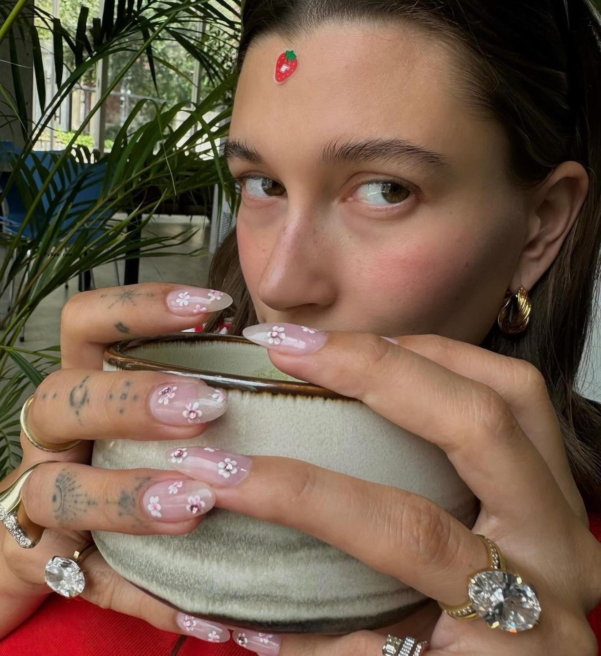 Hailey Bieber showing her new ring.