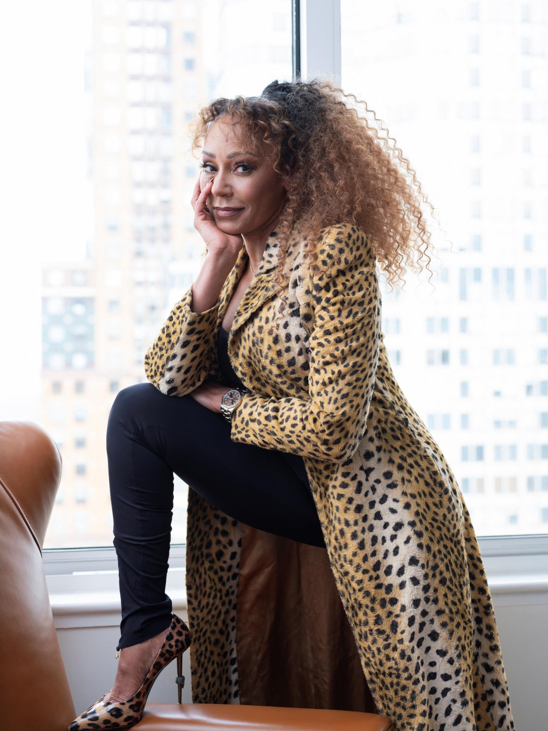 melanie brown with her leg on a table