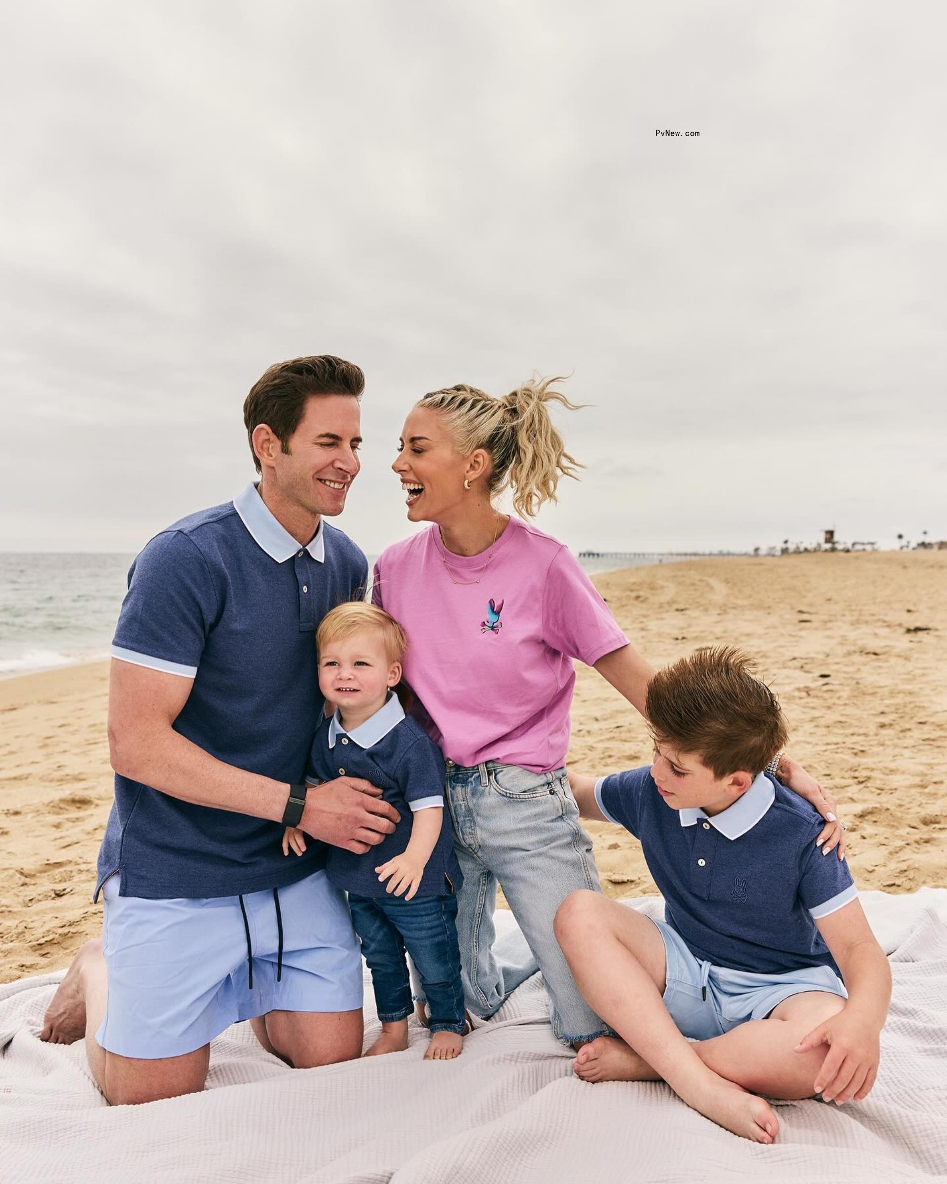 Tarek El Moussa and Heather Rae young posing with their sons on the beach