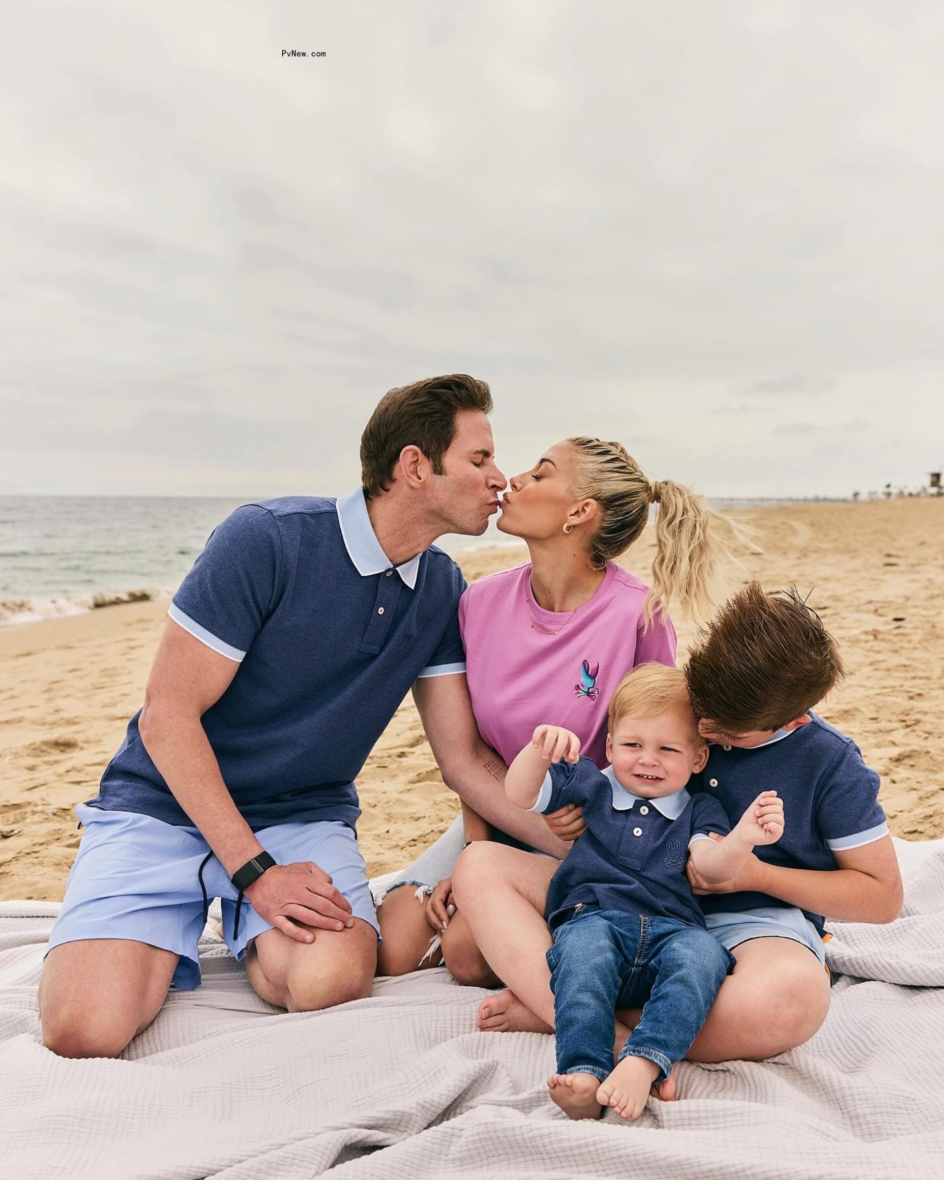 Tarek El Moussa kissing Heather Rae Young with their two sons on the beach