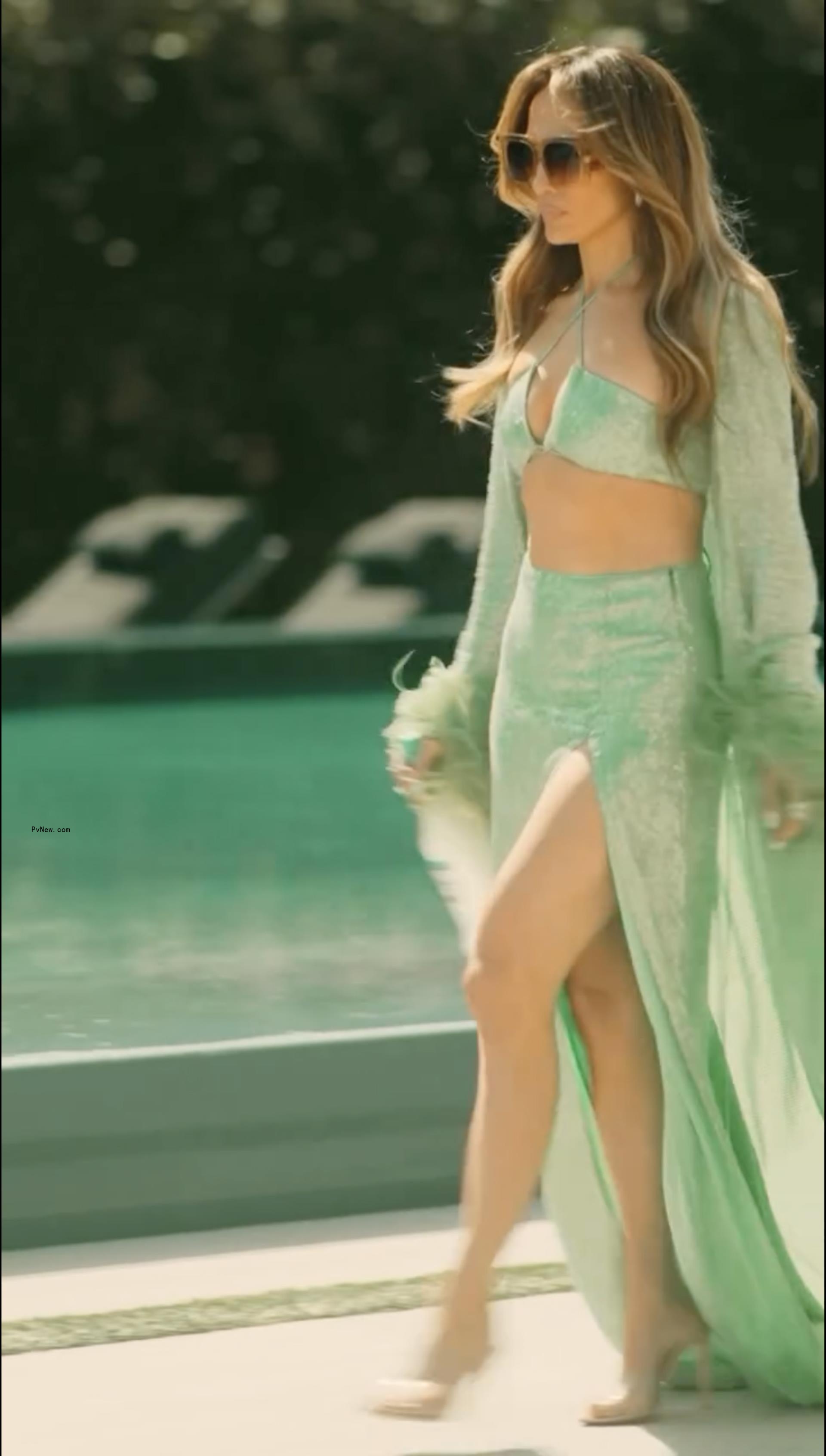 Jennifer Lopez wears green sequin and feather look in Delola Light Margarita ad.