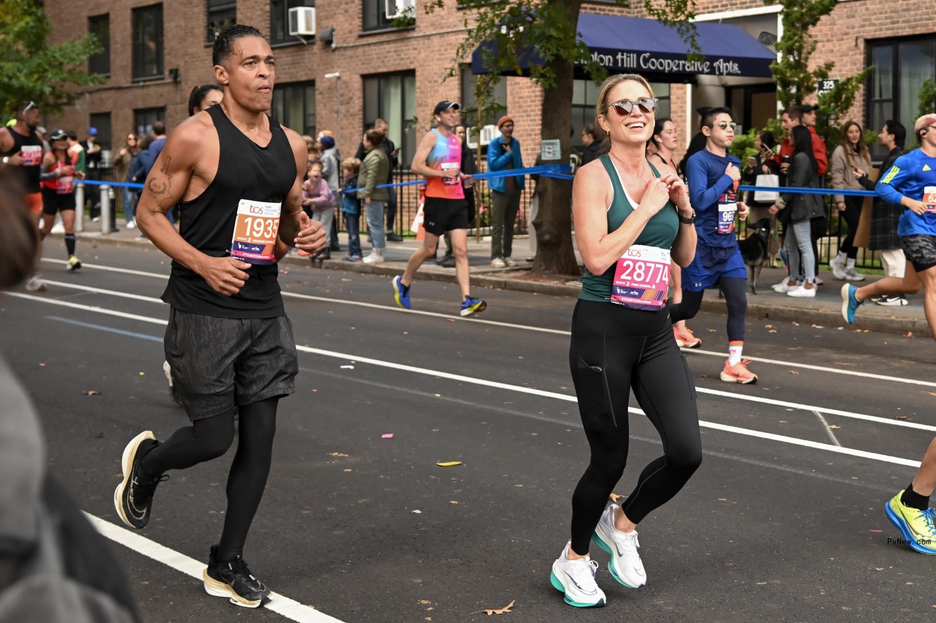 TJ Holmes and Amy Robach run during the 2023 TCS New York City Marathon