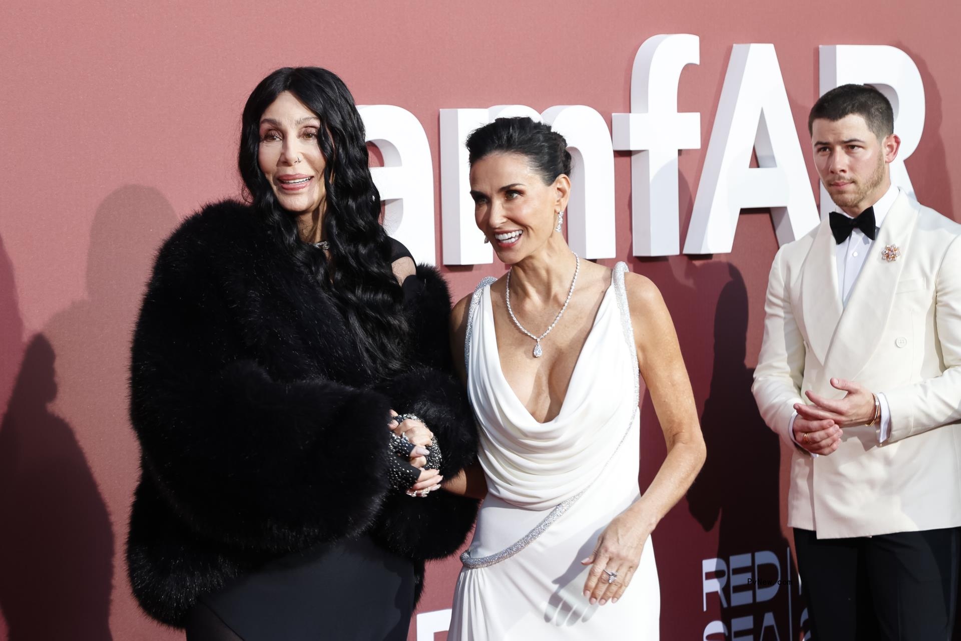 Demo More walks hand in hand with Cher as Nick Jo<i></i>nas walks behind them.