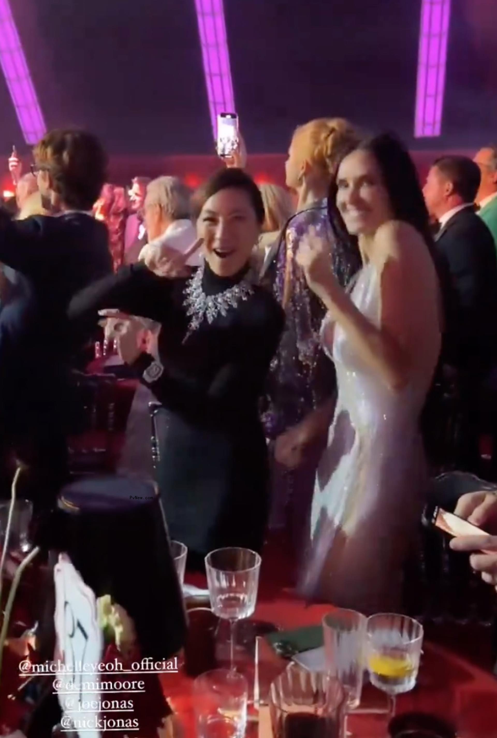 Demi Moore dances with Michelle Yeoh.