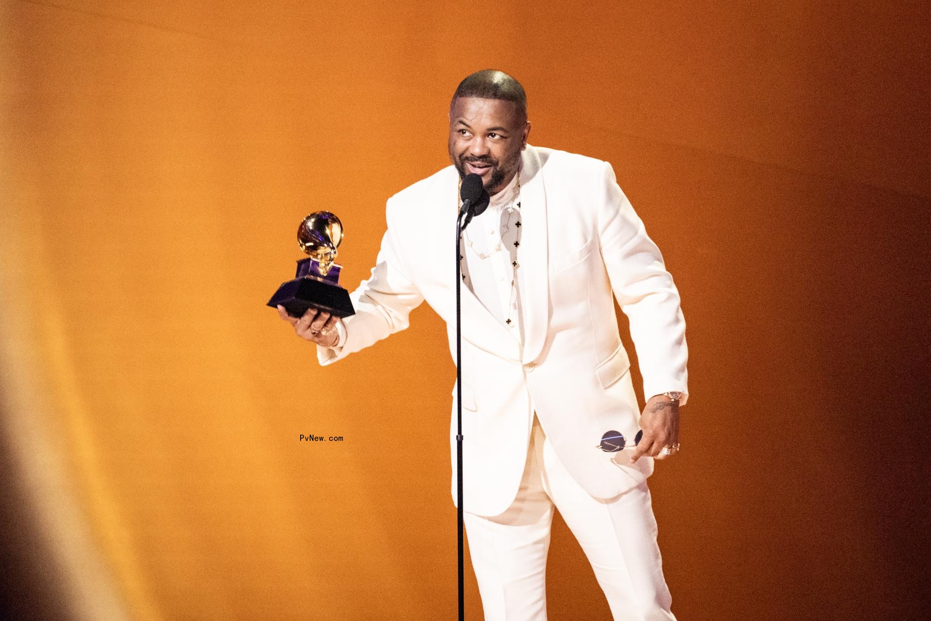 The-Dream holding a Grammy award.
