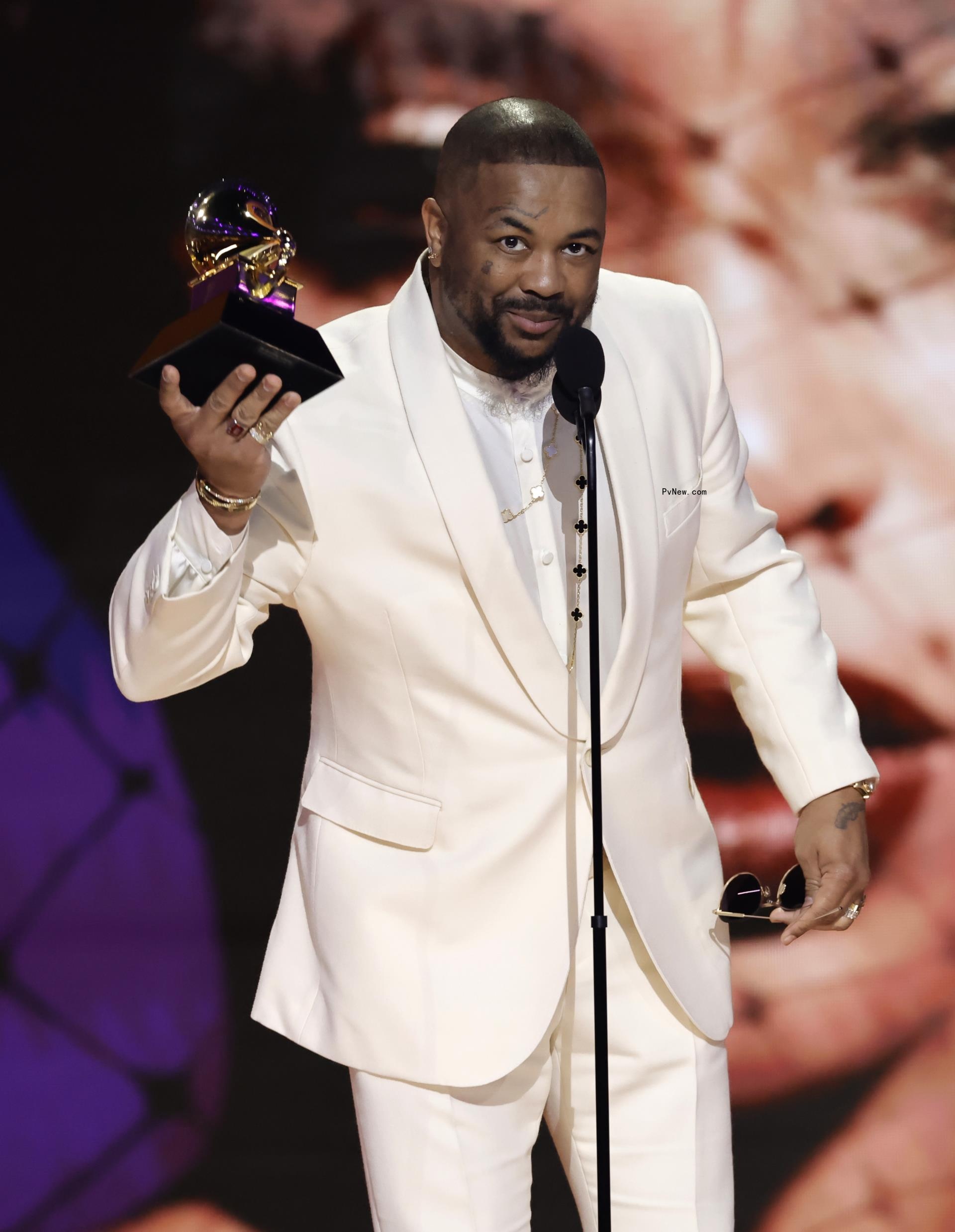 The-Dream holding a Grammy award.