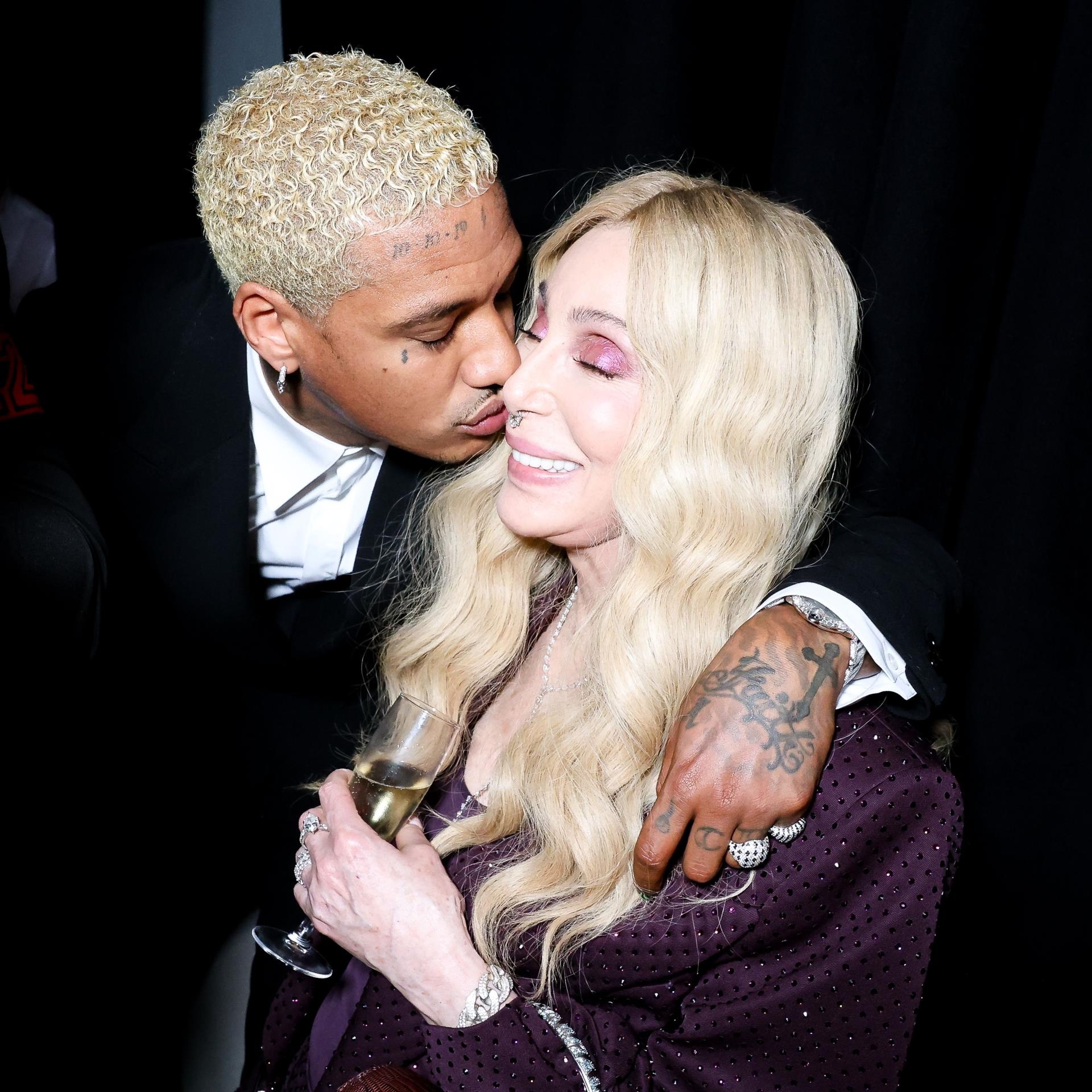 Alexander Edwards kissing Cher's cheek in Cannes.