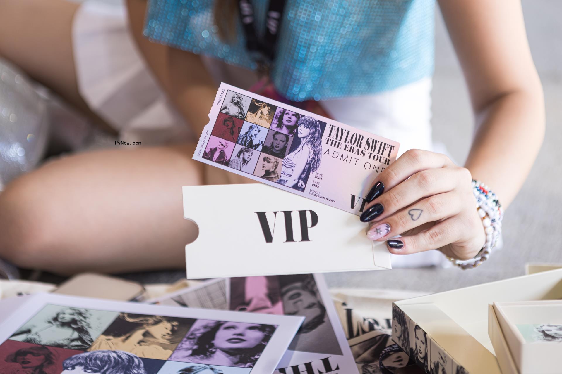 A person holding a Taylor Swift co<i></i>ncert ticket.