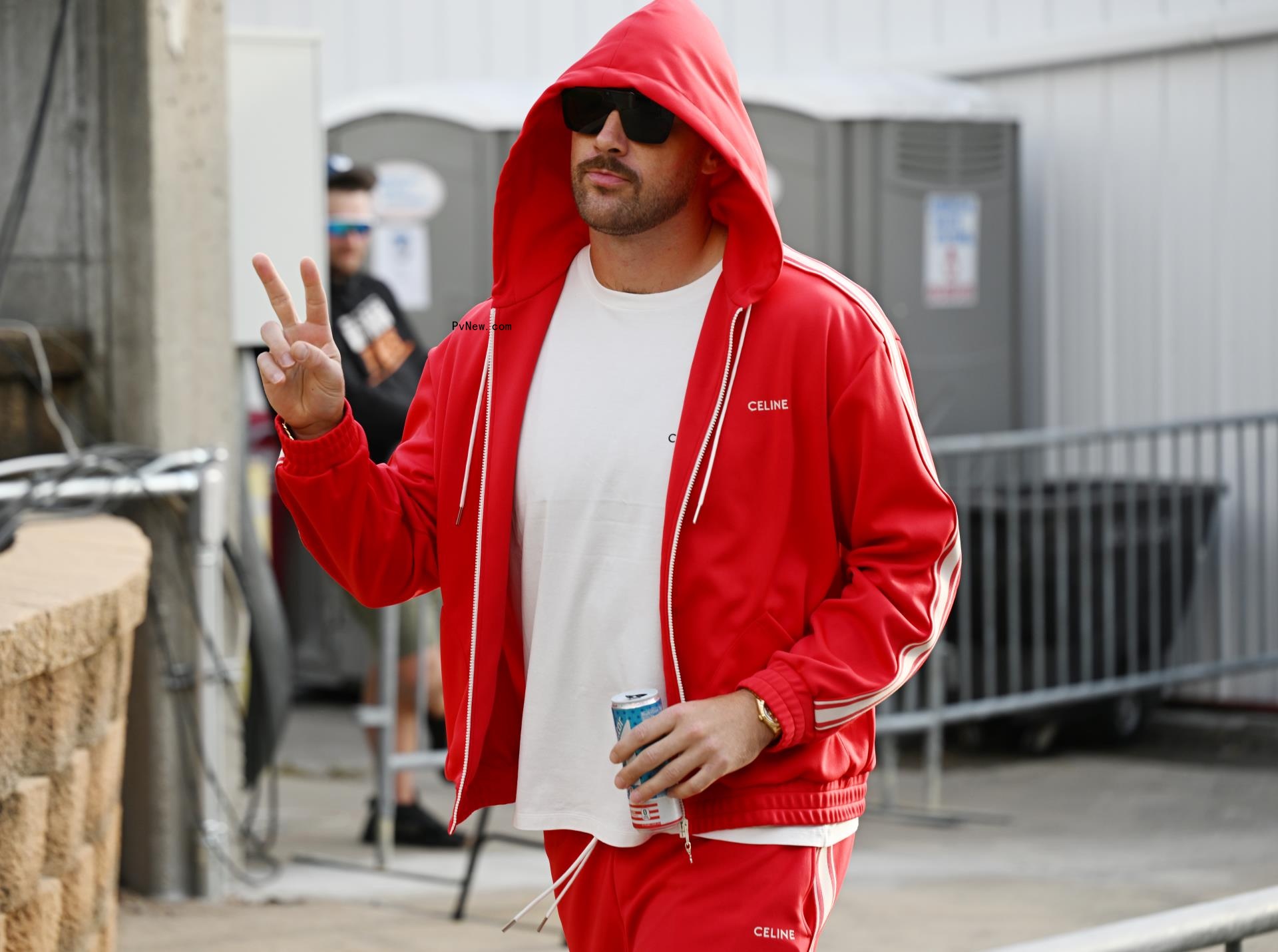 Travis Kelce walking in a sweatsuit