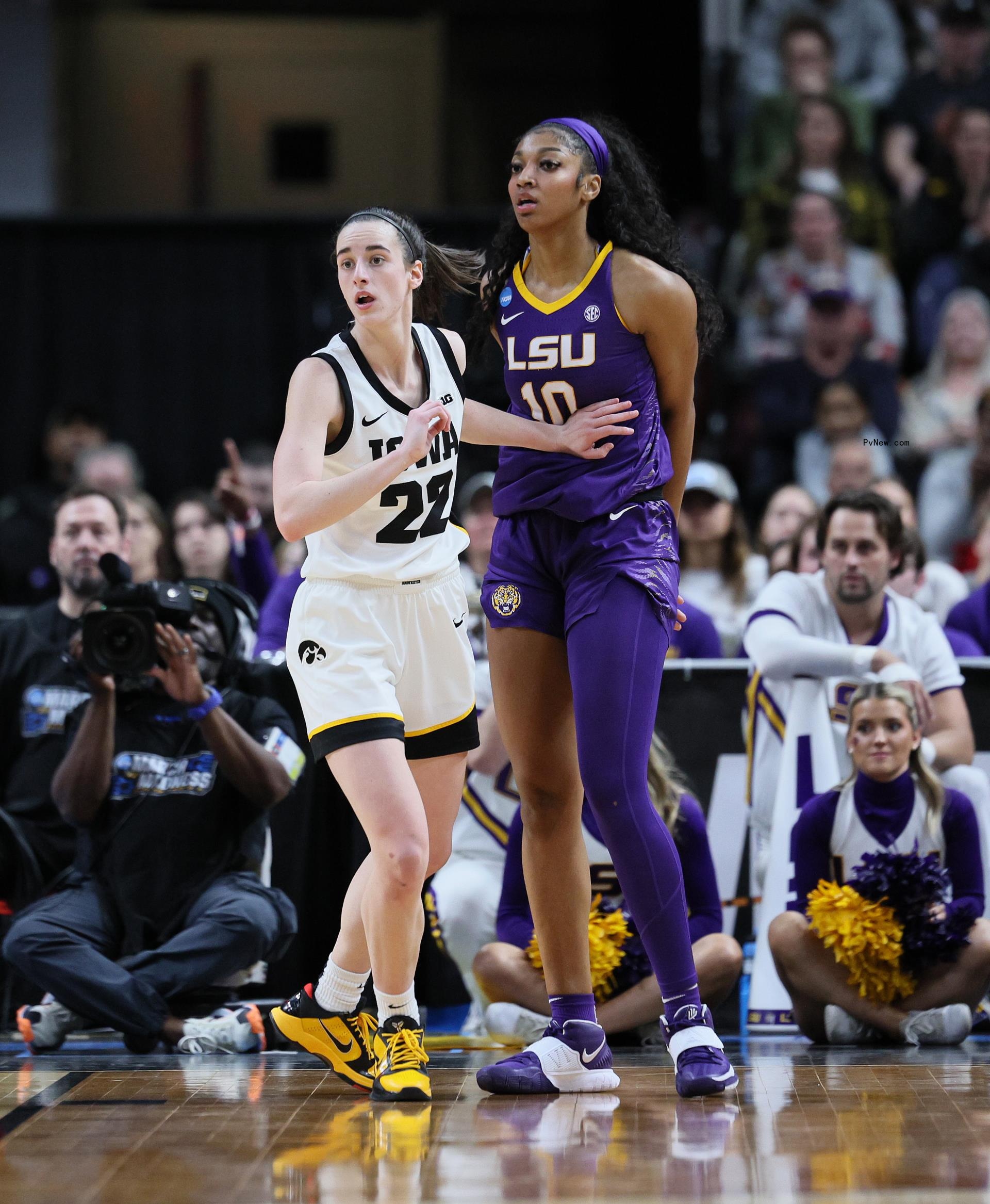 Angel Reese and Caitlin Clark playing basketball.