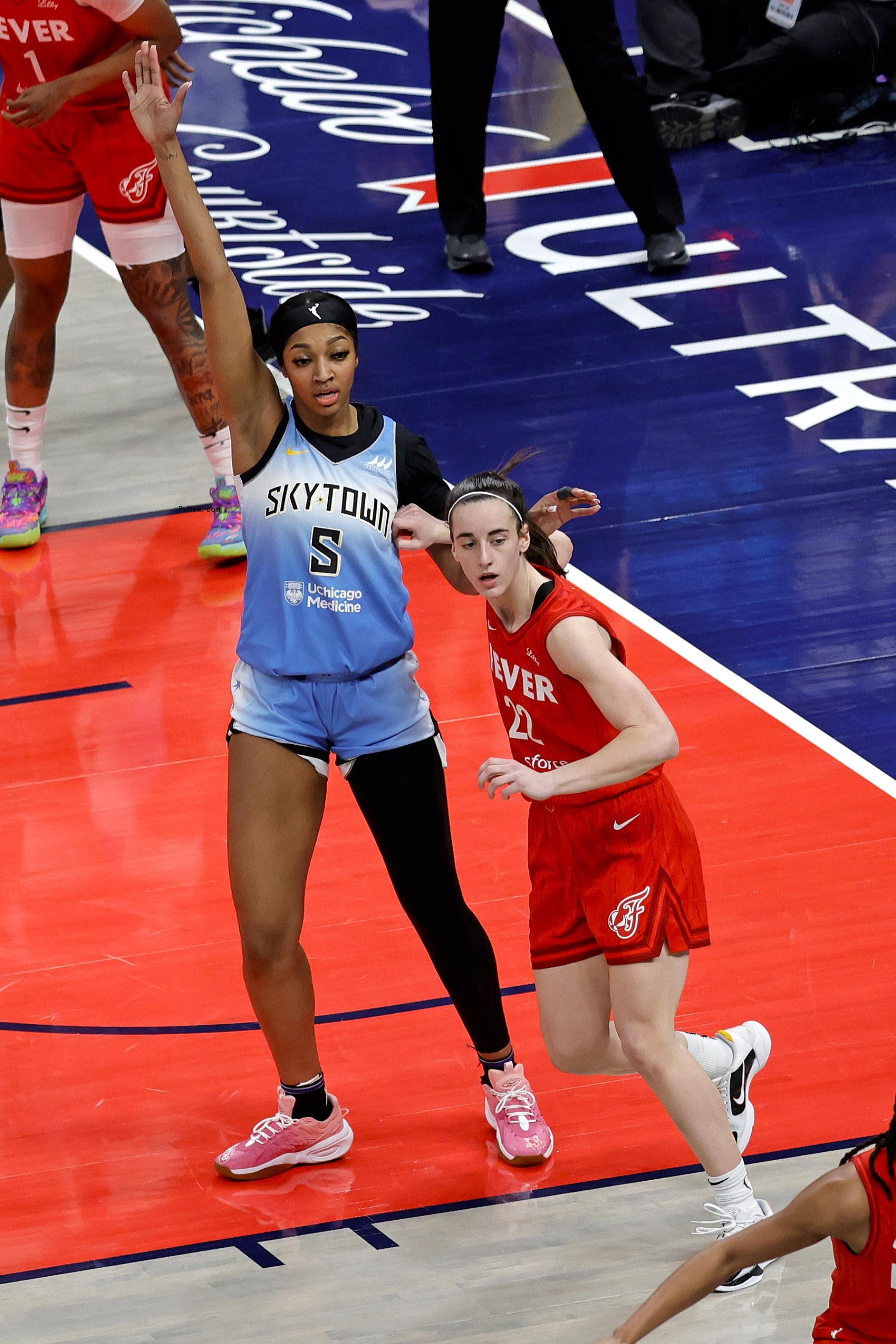 Angel Reese and Caitlin Clark playing basketball.