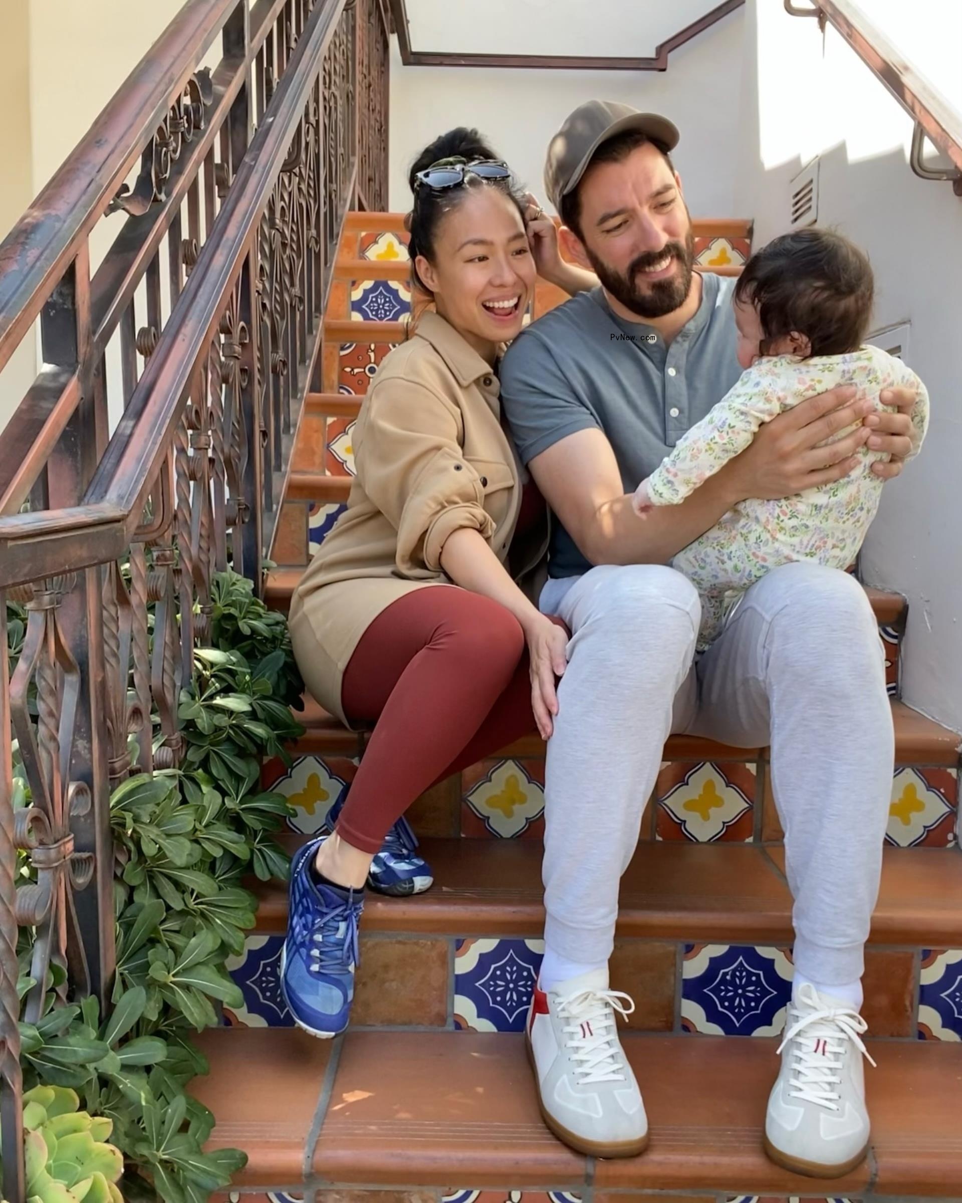 Drew Scott and wife Linda Phan with their son Parker on steps