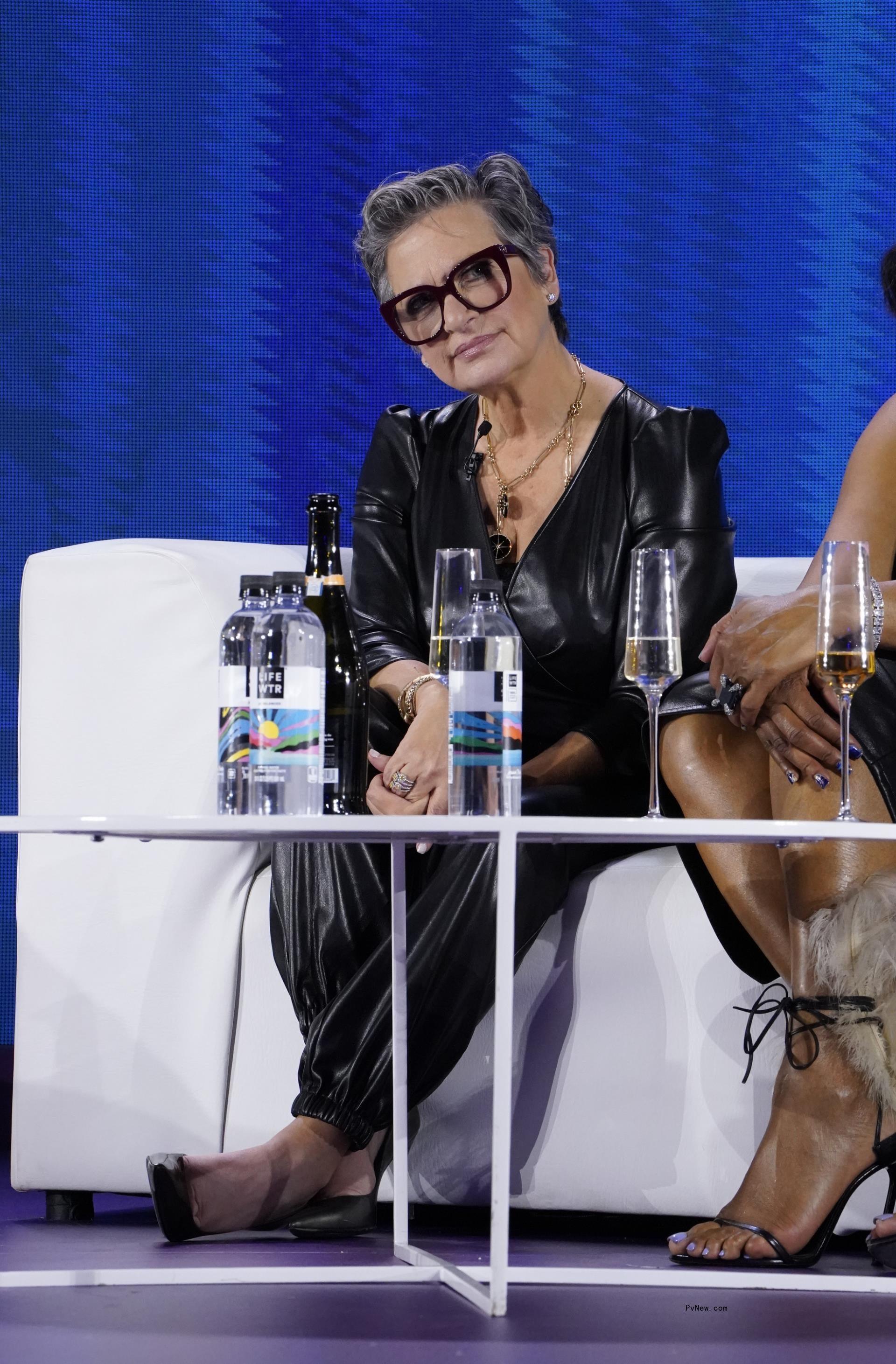 caroline manzo sitting on a couch
