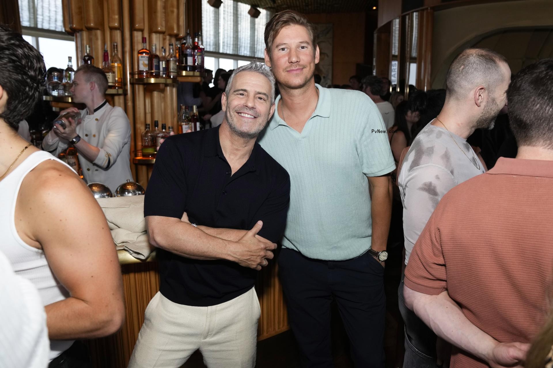 Andy Cohen and Austen Kroll posing together