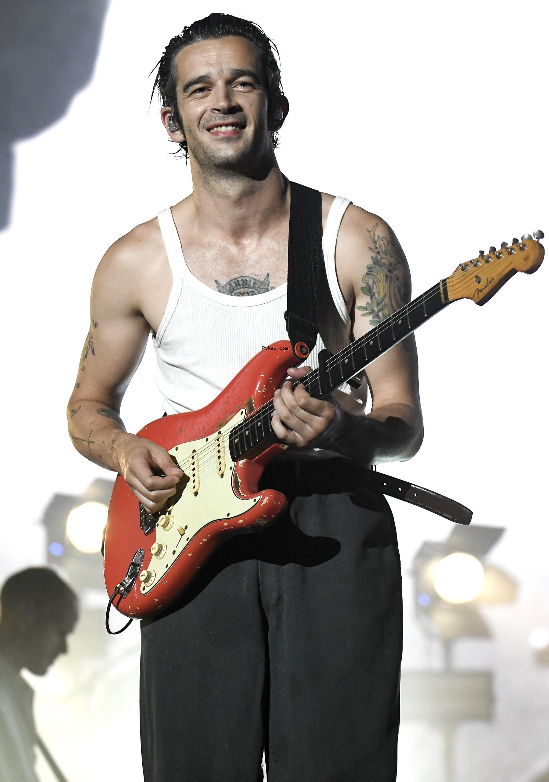 Matty Healy performing on stage.