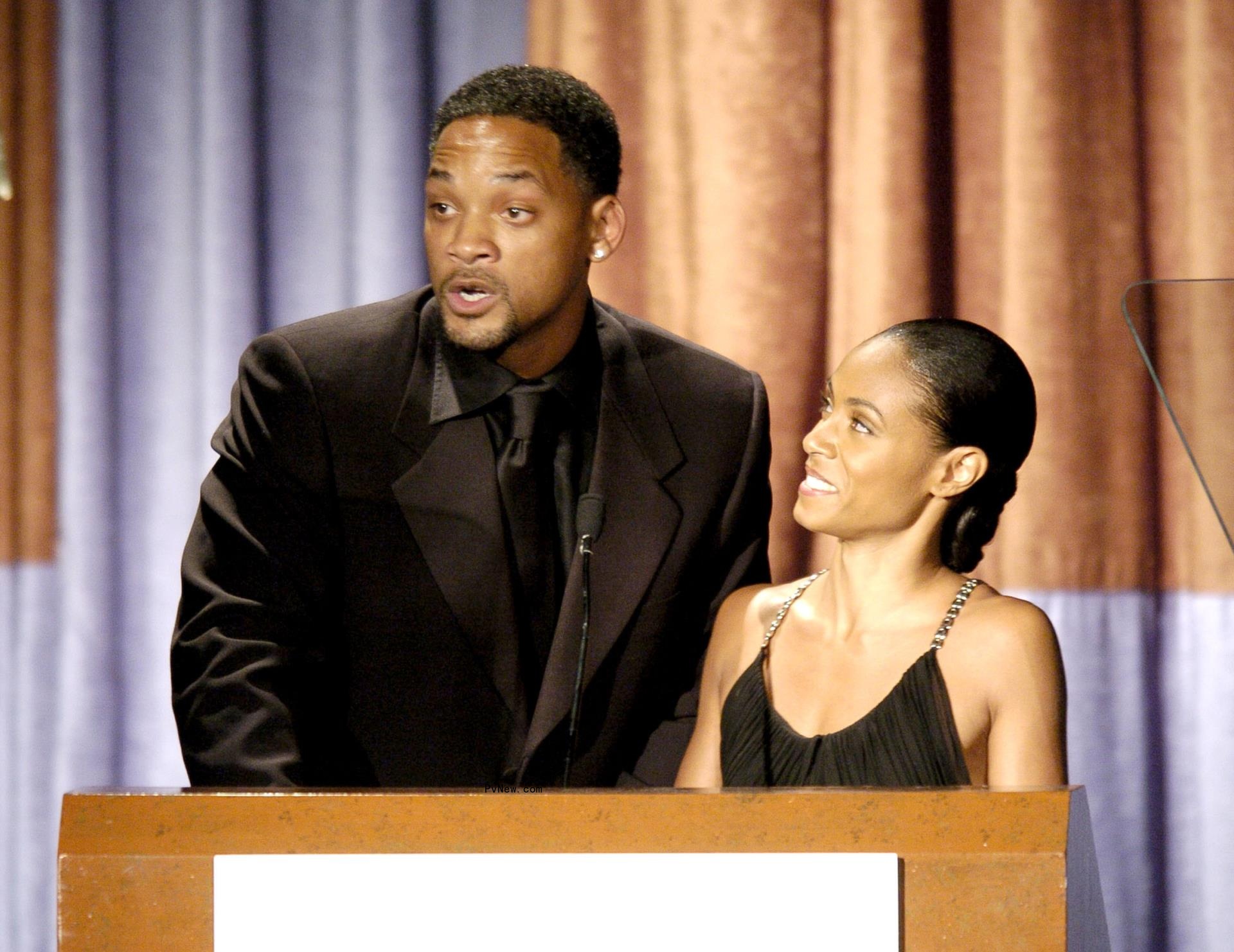 Jada Pinkett and Will Smith presenting an award.
