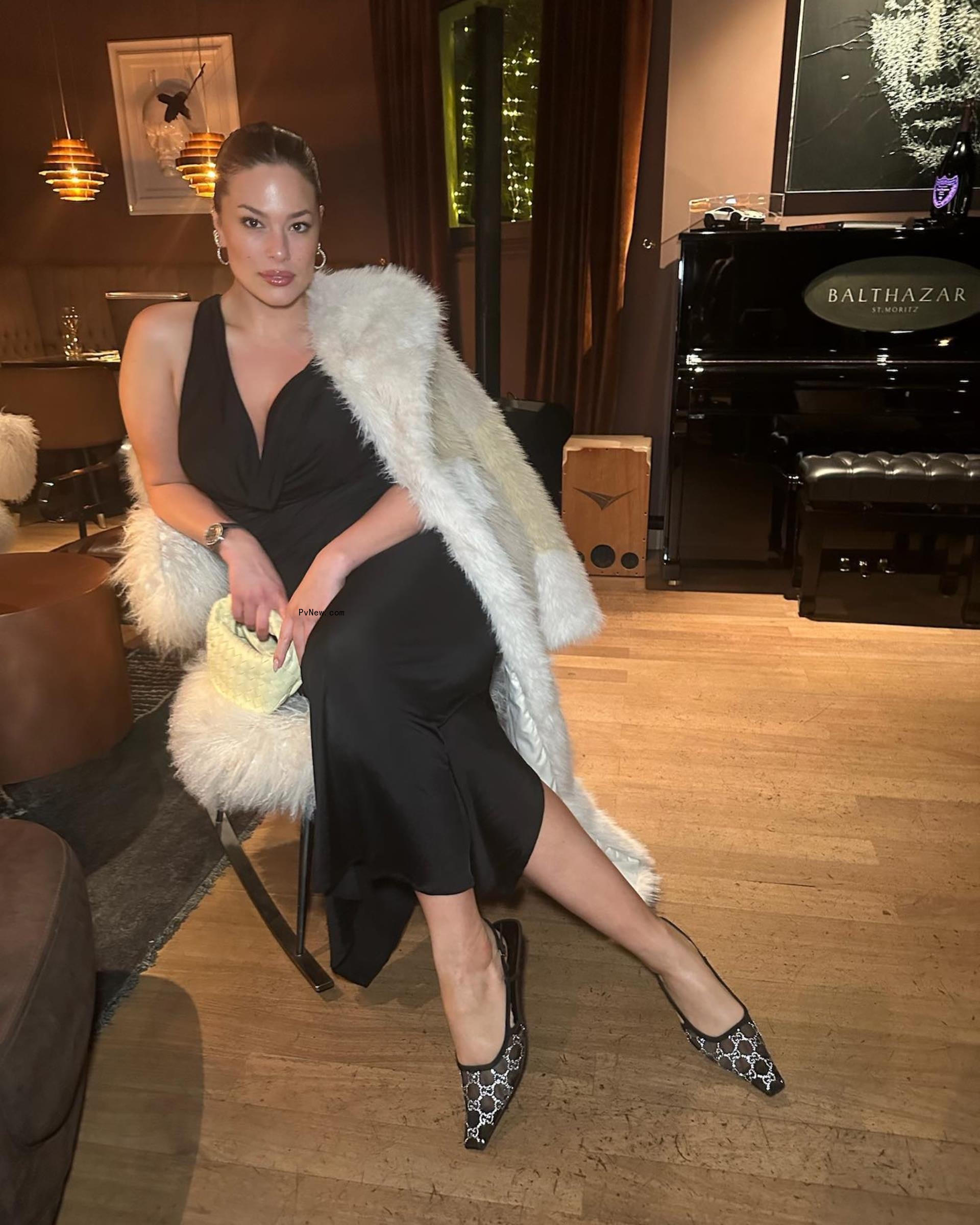 Ashley Graham sitting in a chair. 