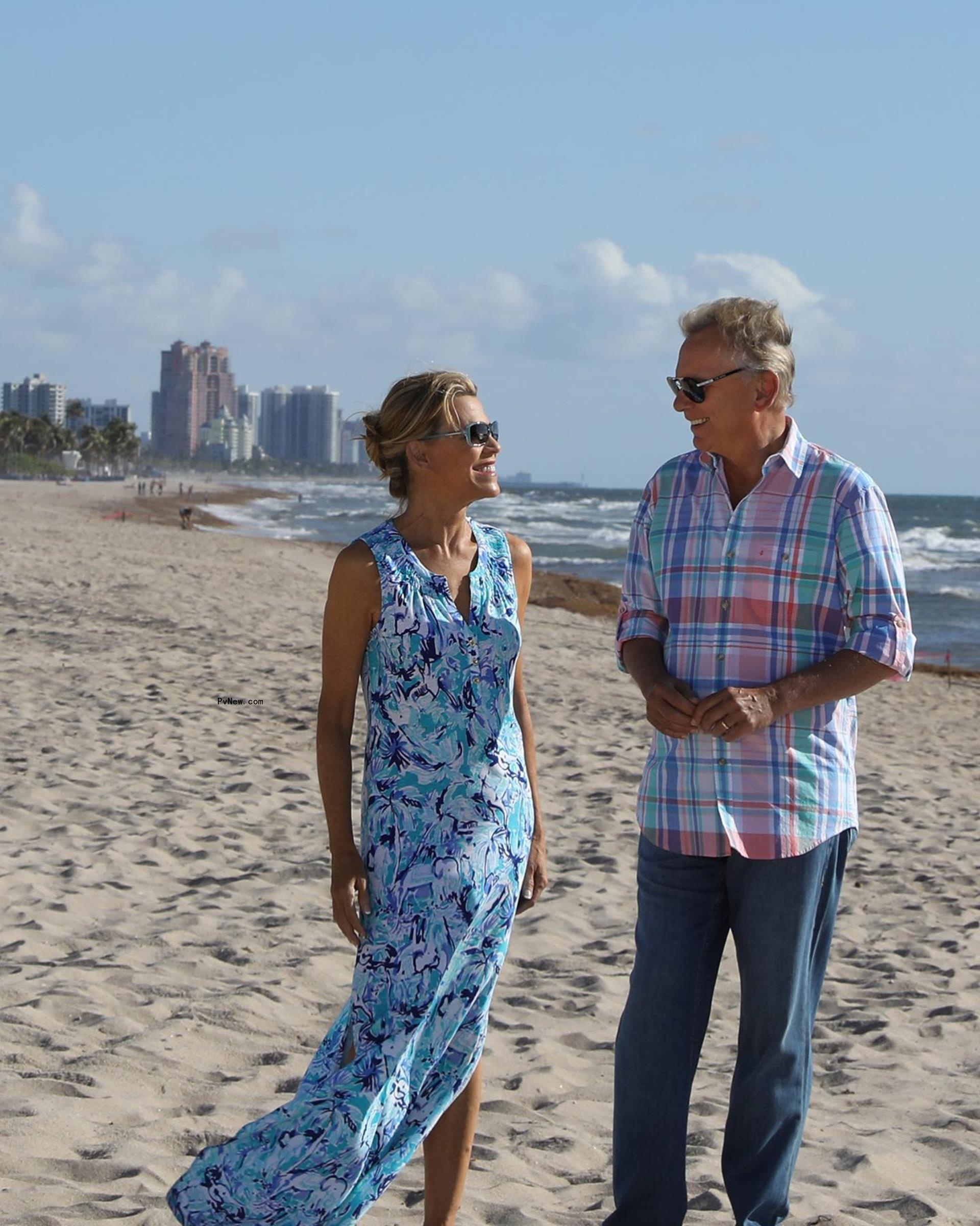 Vanna White and Pat Sajak pose on the beach