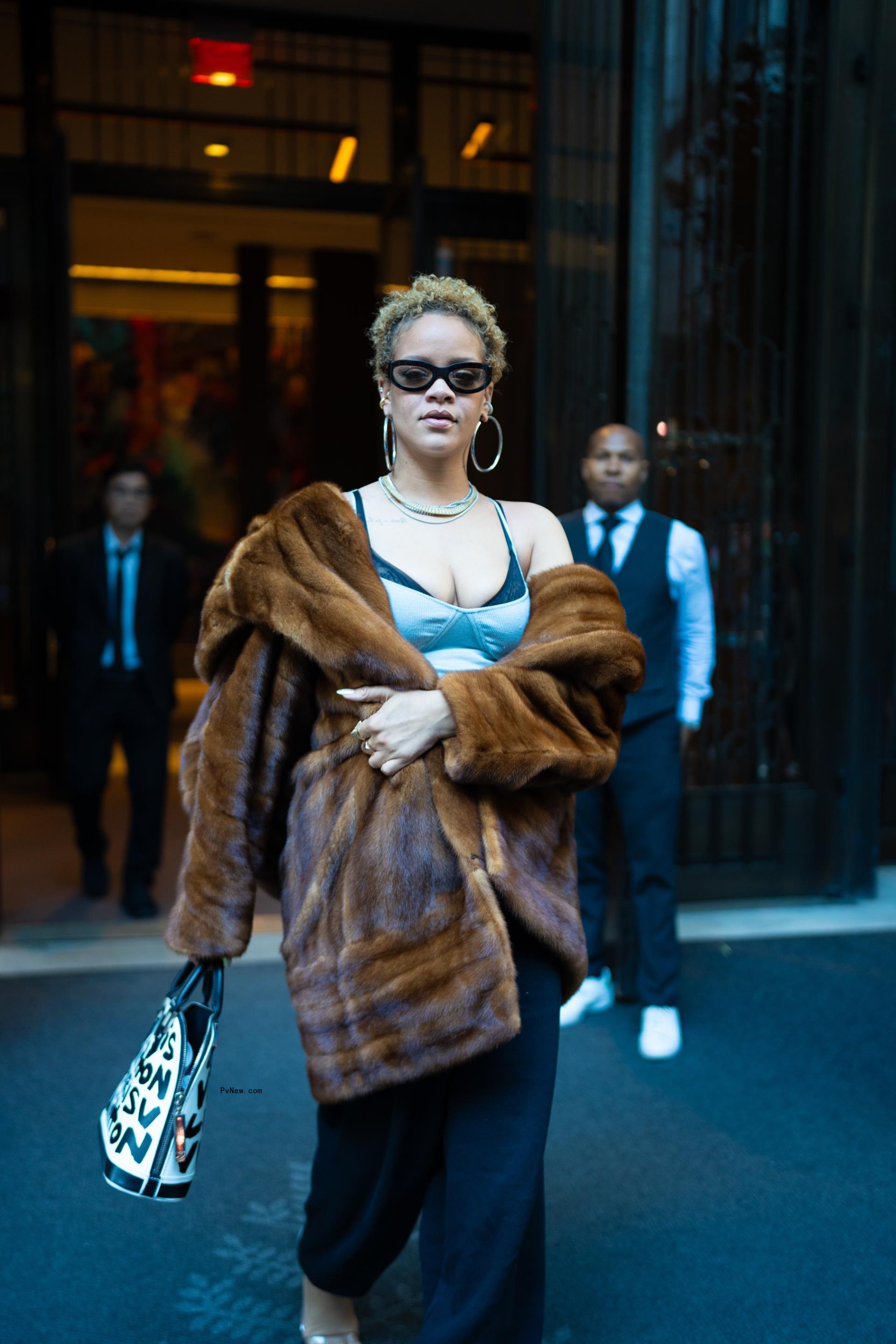 Rihanna wears her hair in natural curls